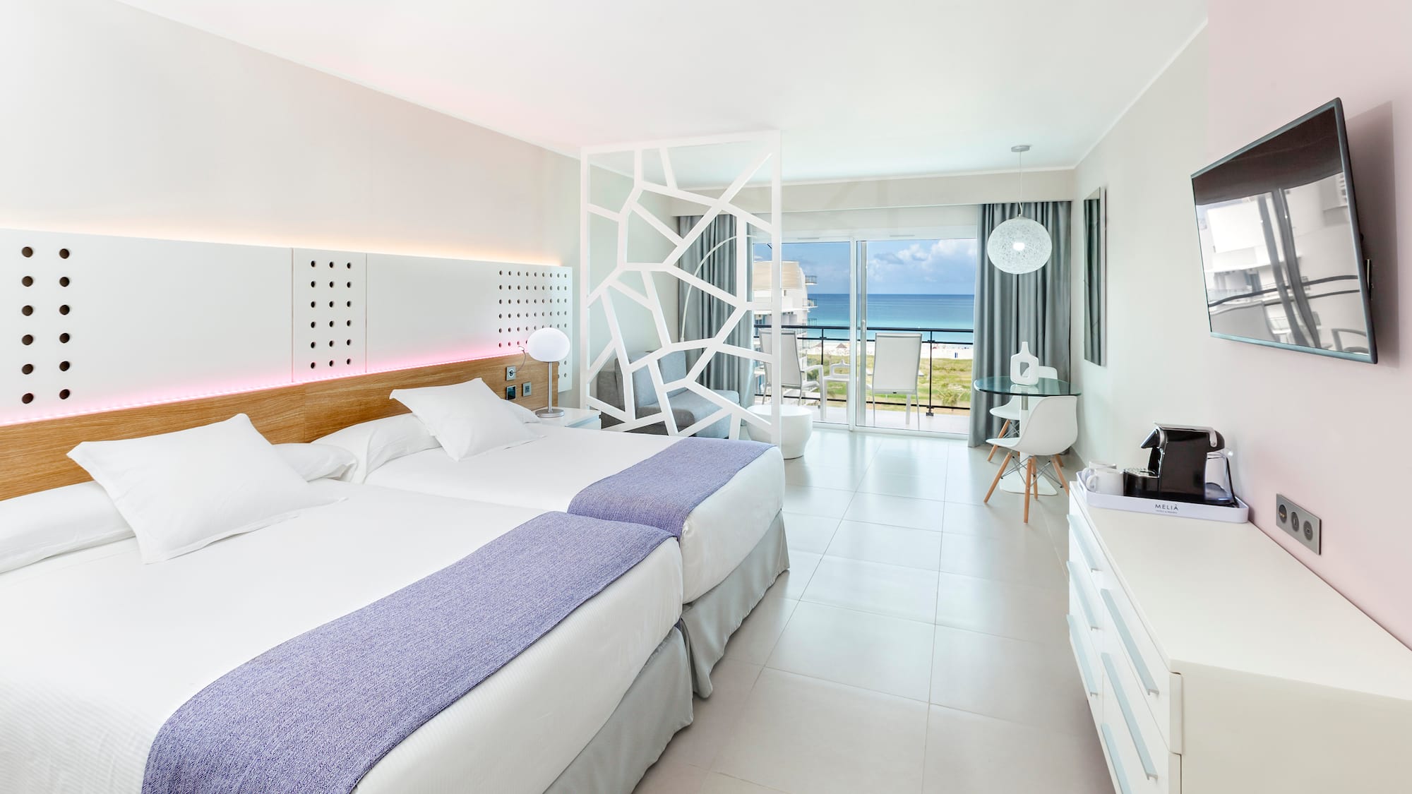 a room with two beds and a glass door