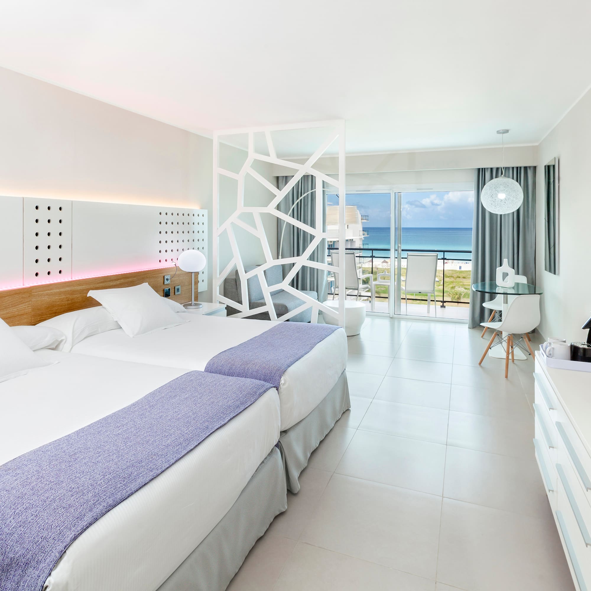 a room with two beds and a glass door