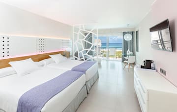 a room with two beds and a glass door