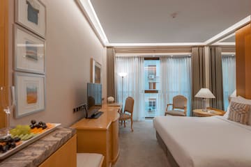 a room with a bed and a table and chairs