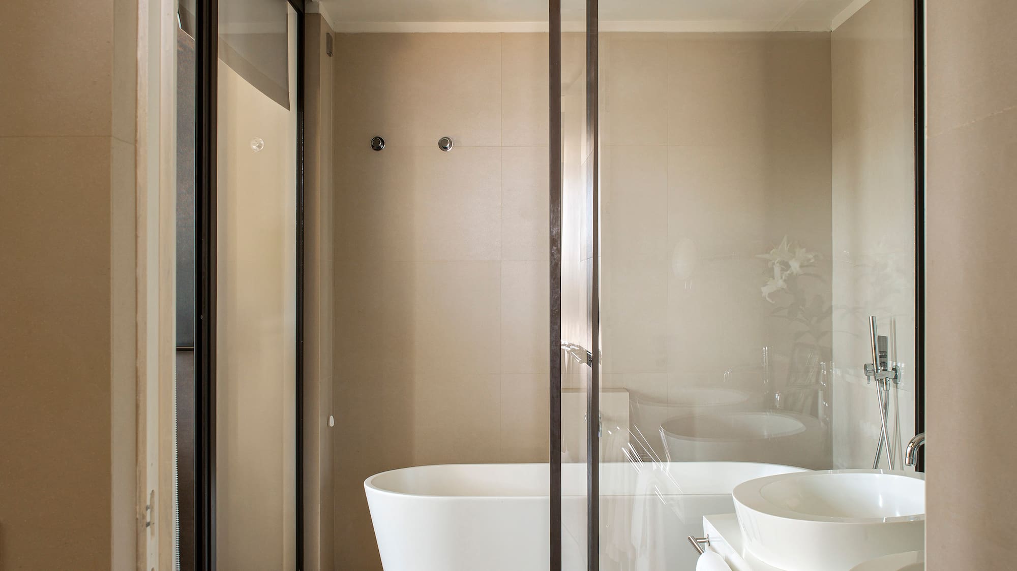 a bathroom with a glass shower door