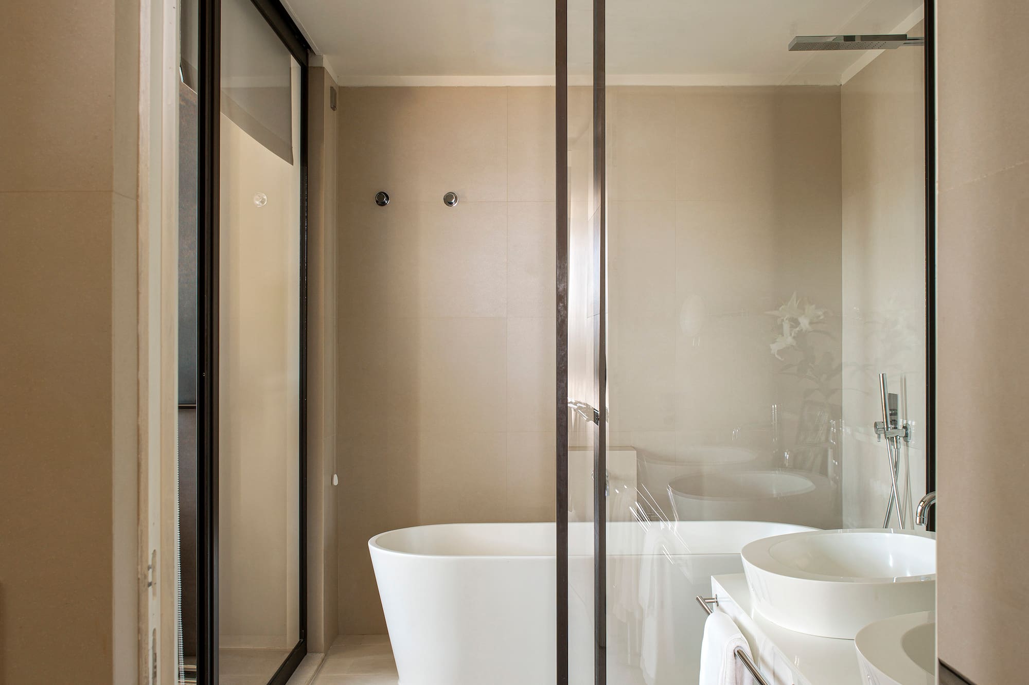 a bathroom with a glass shower door