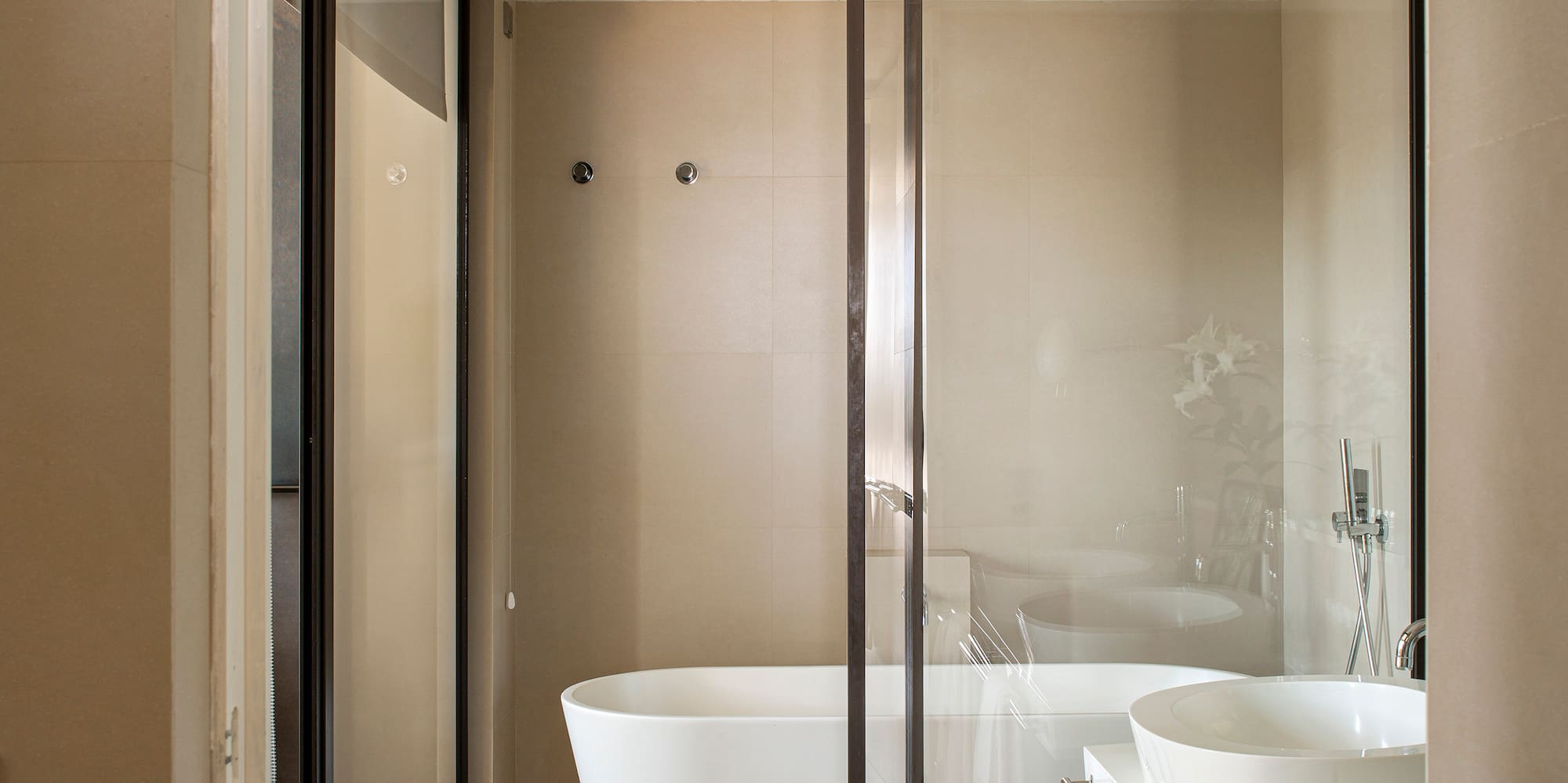 a bathroom with a glass shower door
