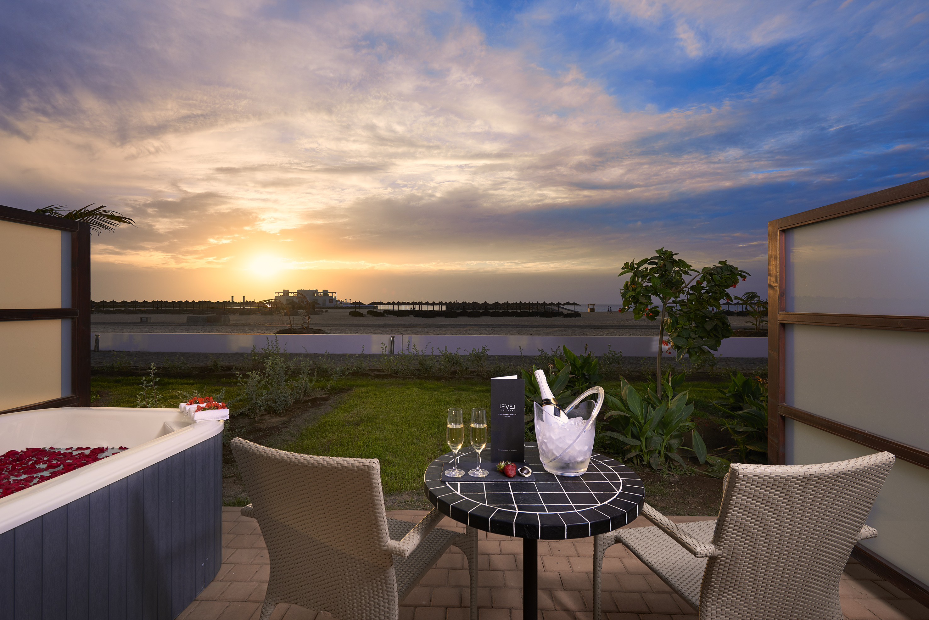 a table with wine glasses and a hot tub in the background