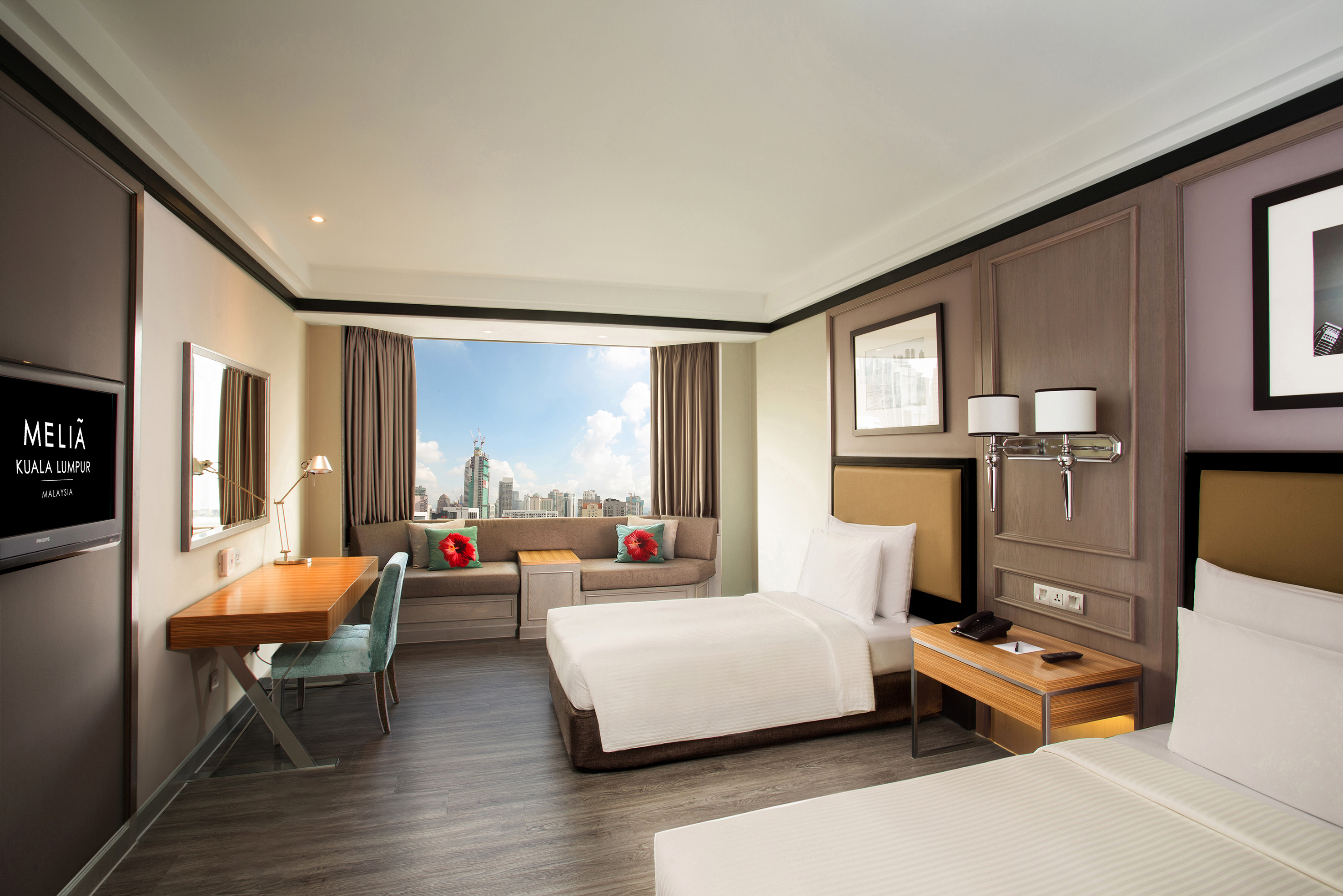 a room with two beds and a desk