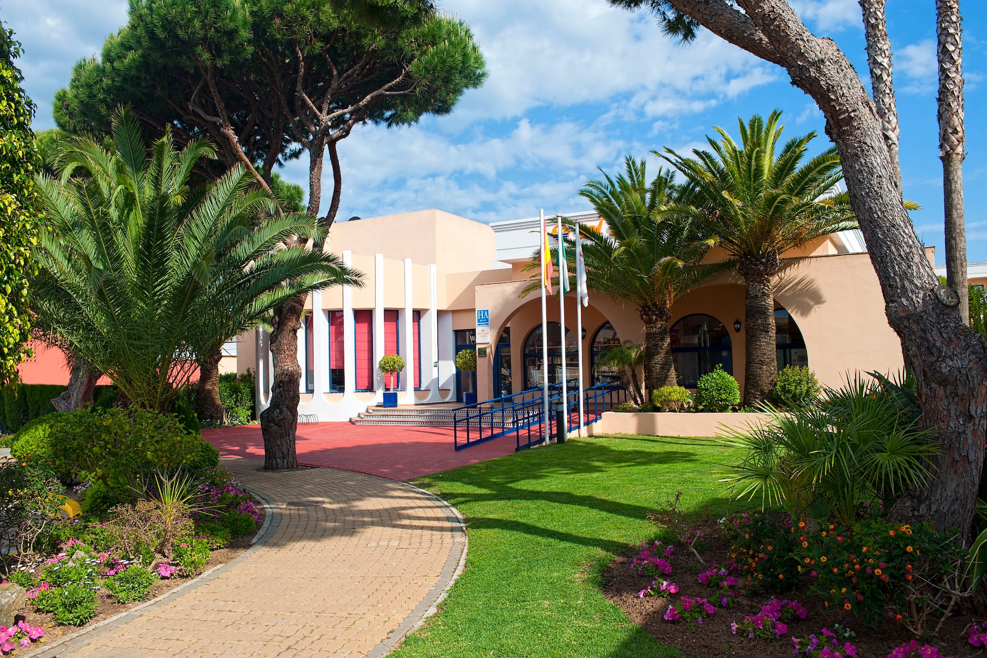 a building with a lawn and trees