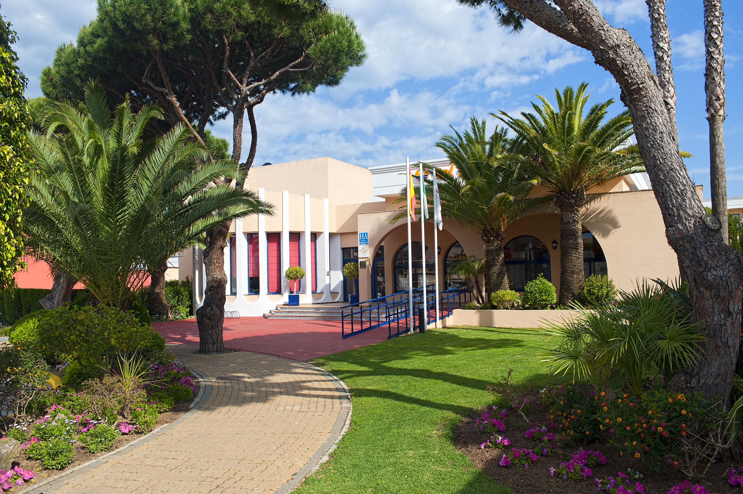 a building with a lawn and trees