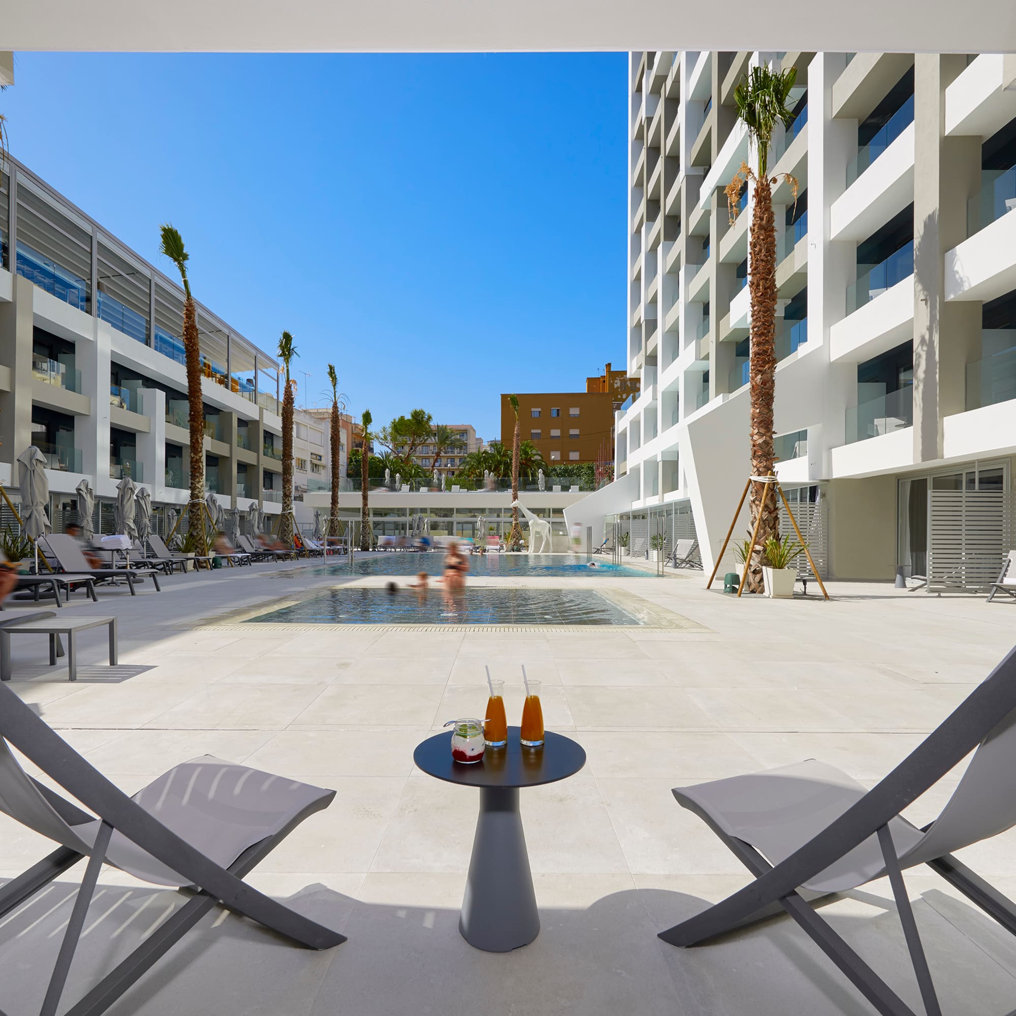 a pool with a couple of chairs and a table