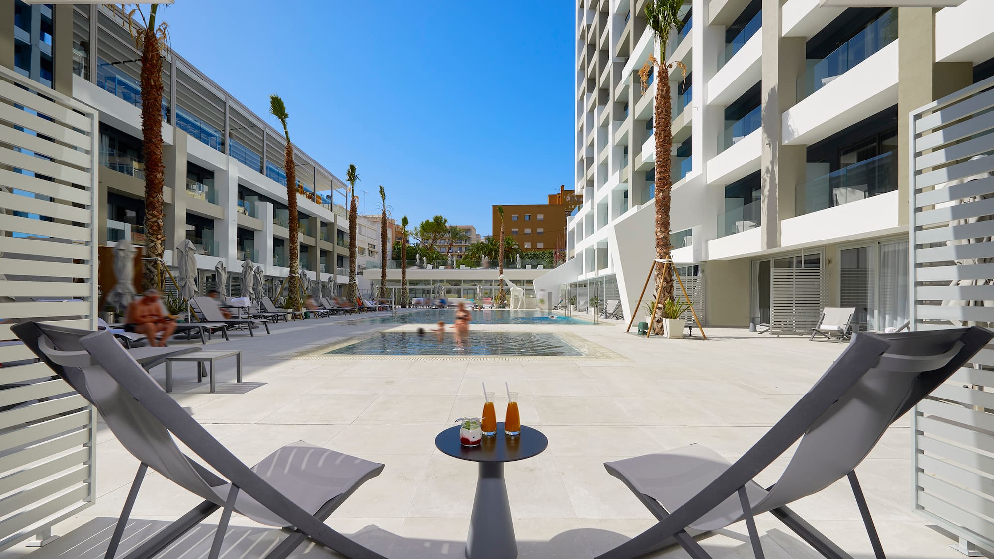 a pool with a couple of chairs and a table