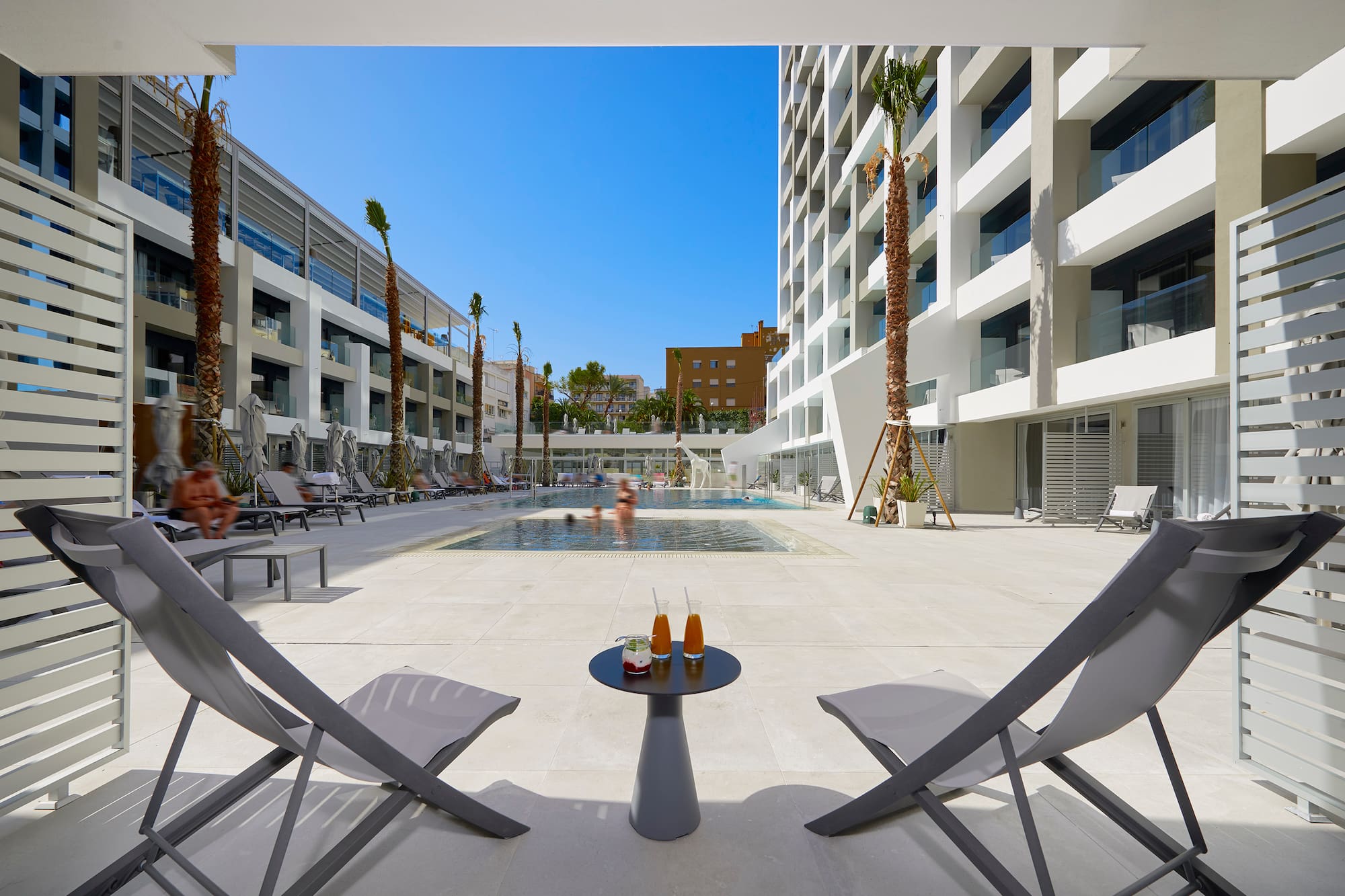 a pool with a couple of chairs and a table