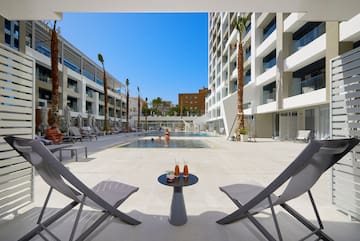 a pool with a couple of chairs and a table