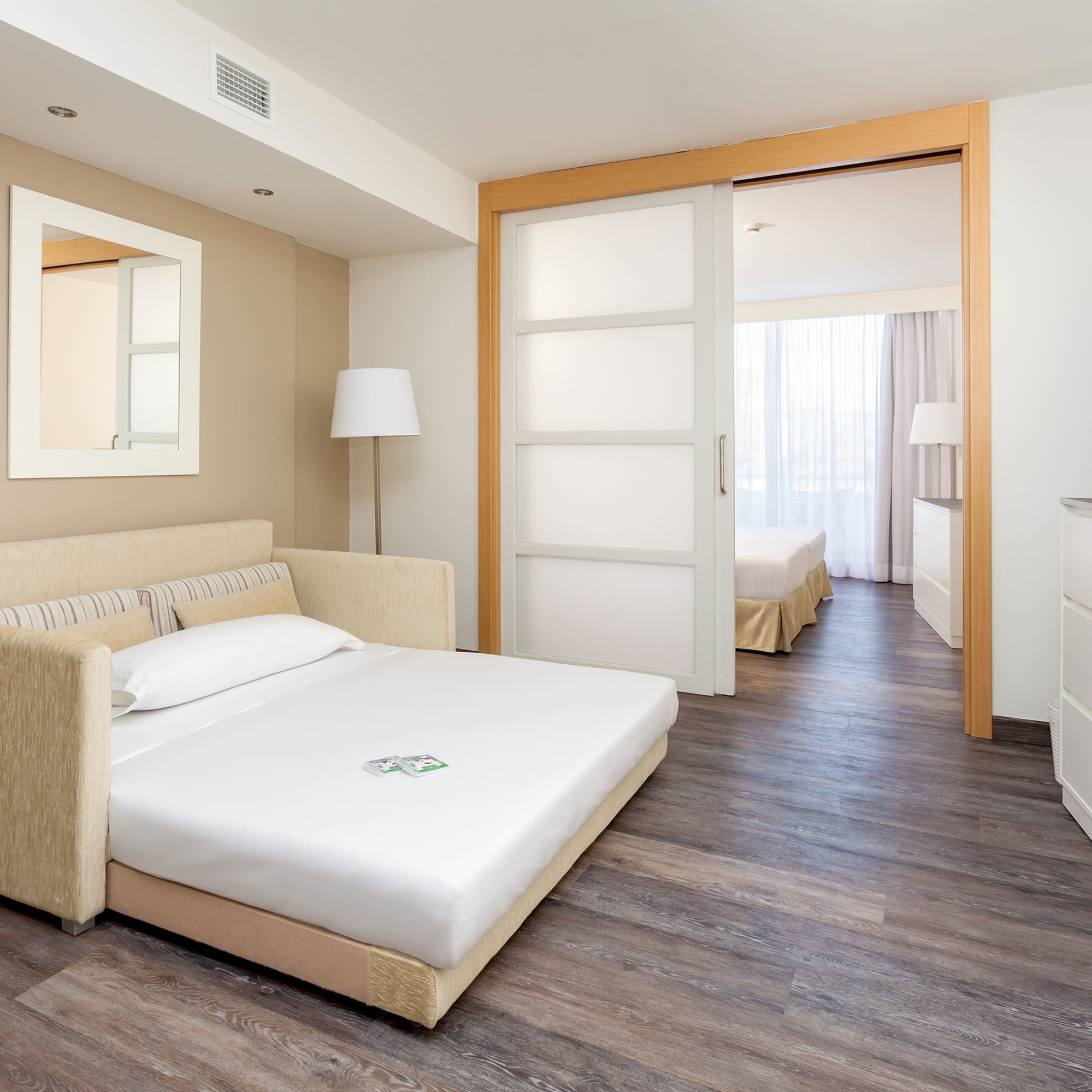 a bedroom with a bed and a wood floor