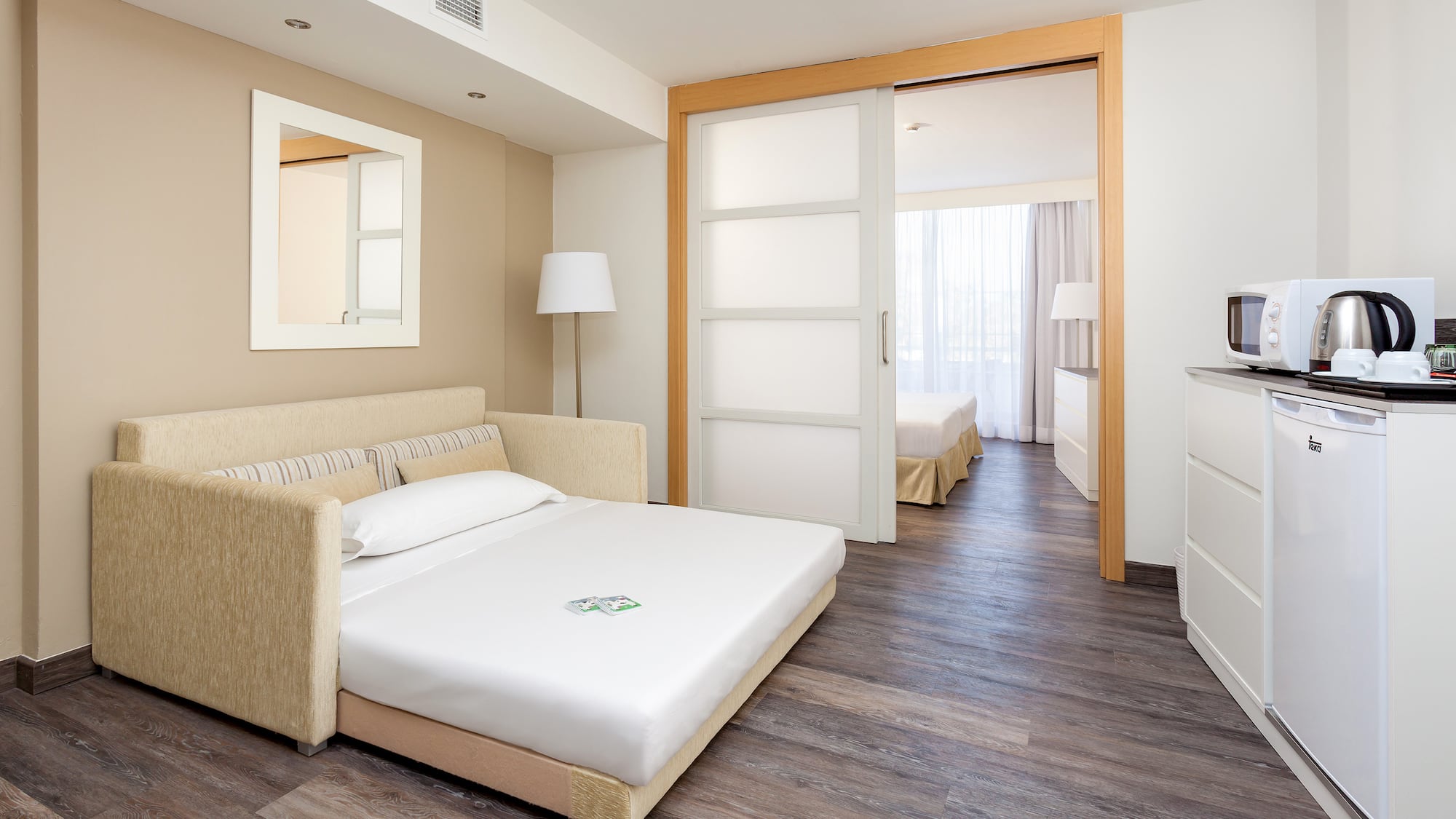 a bedroom with a bed and a wood floor