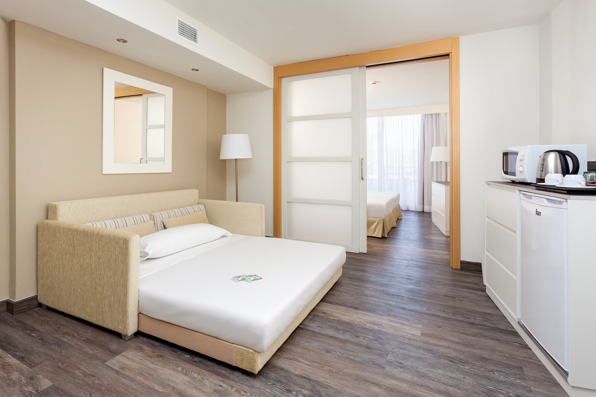 a bedroom with a bed and a wood floor