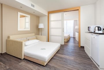 a bedroom with a bed and a wood floor