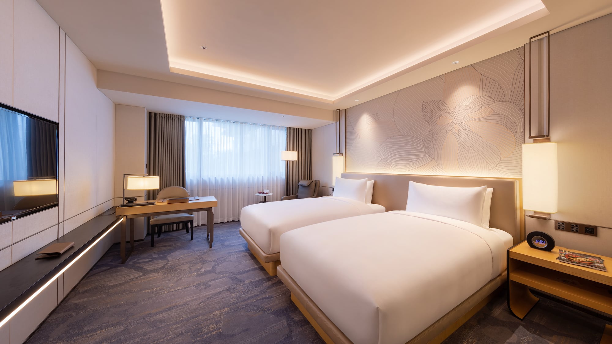 a room with two beds and a desk