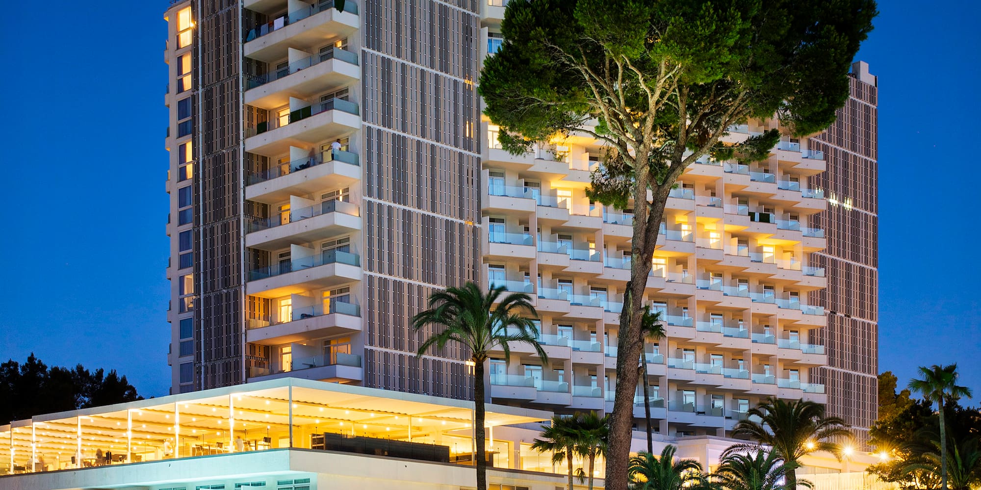 a hotel with a pool and trees