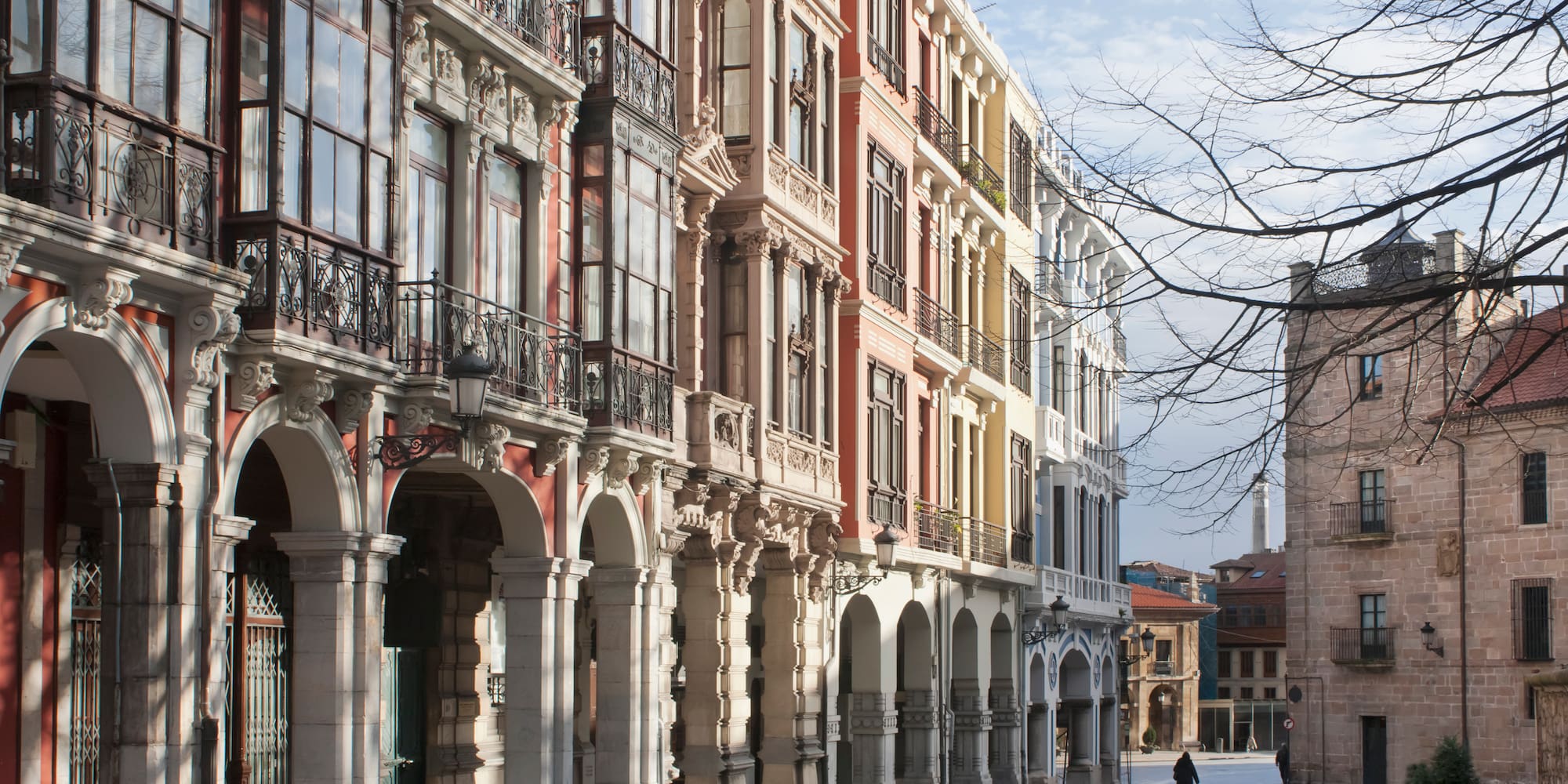 a person walking on a street with buildings