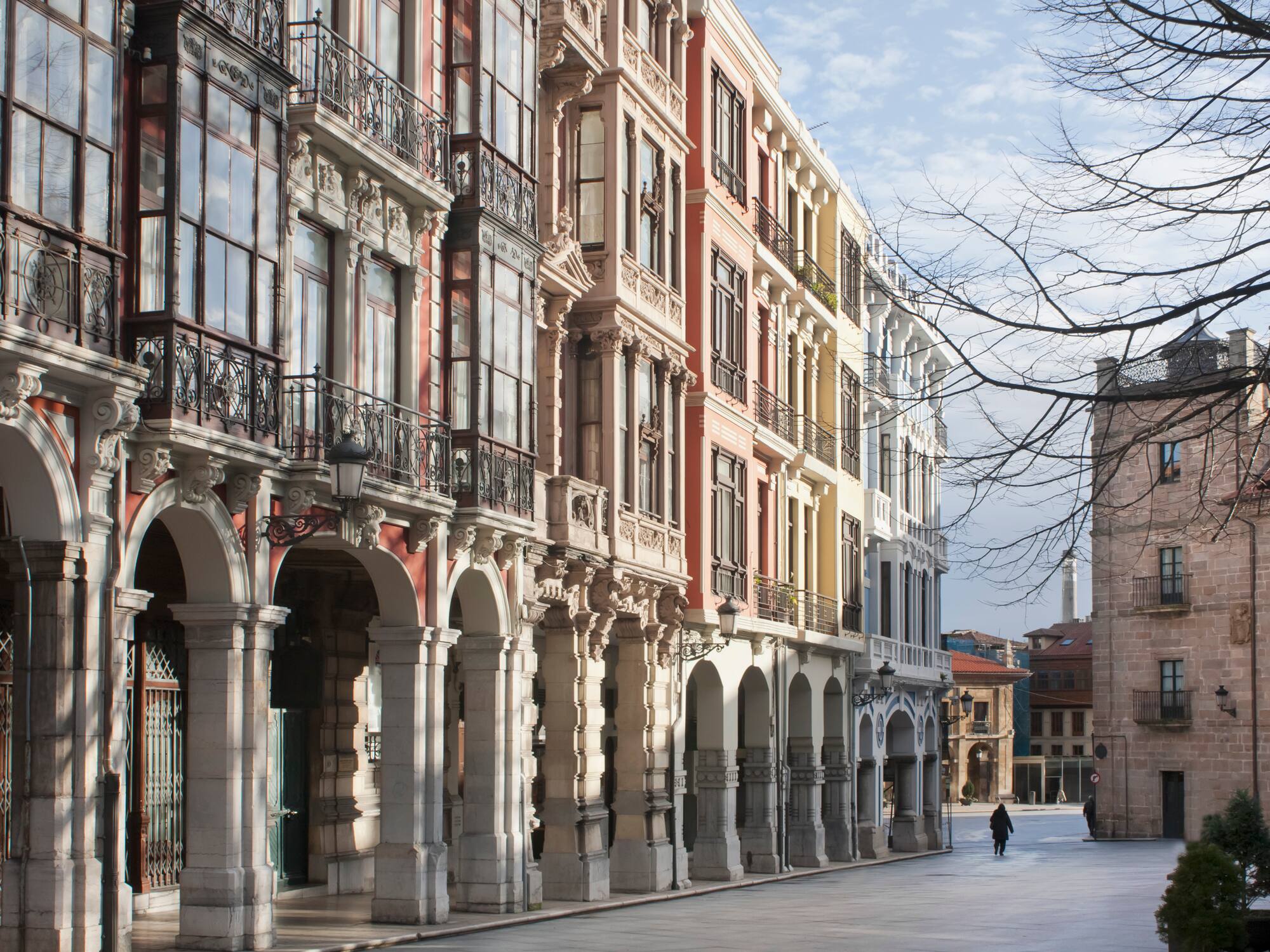 a person walking on a street with buildings