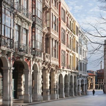 a person walking on a street with buildings