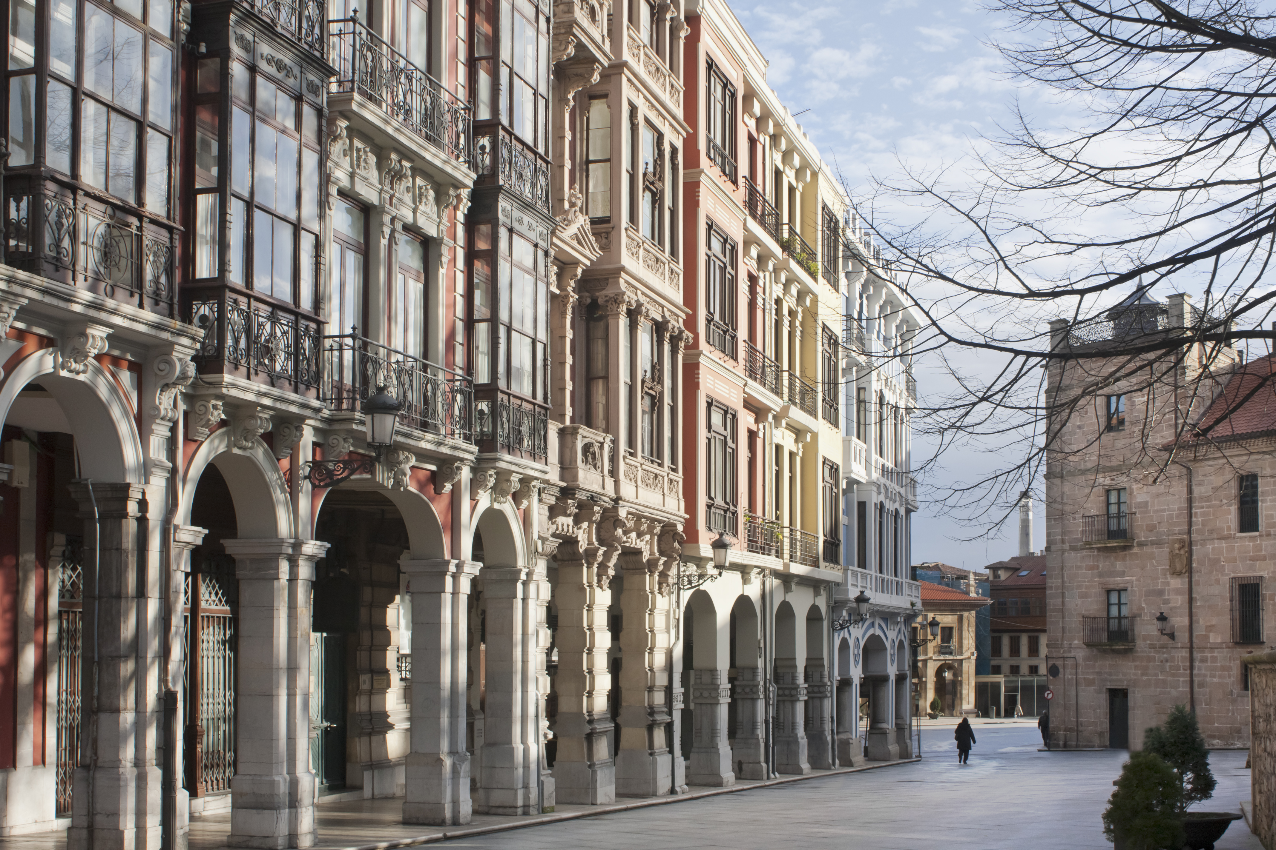 Historic European street with ornate buildings, arched porticos, and balconies. - Avilés - Palacio de Avilés Afiliat Meliá, Avilés