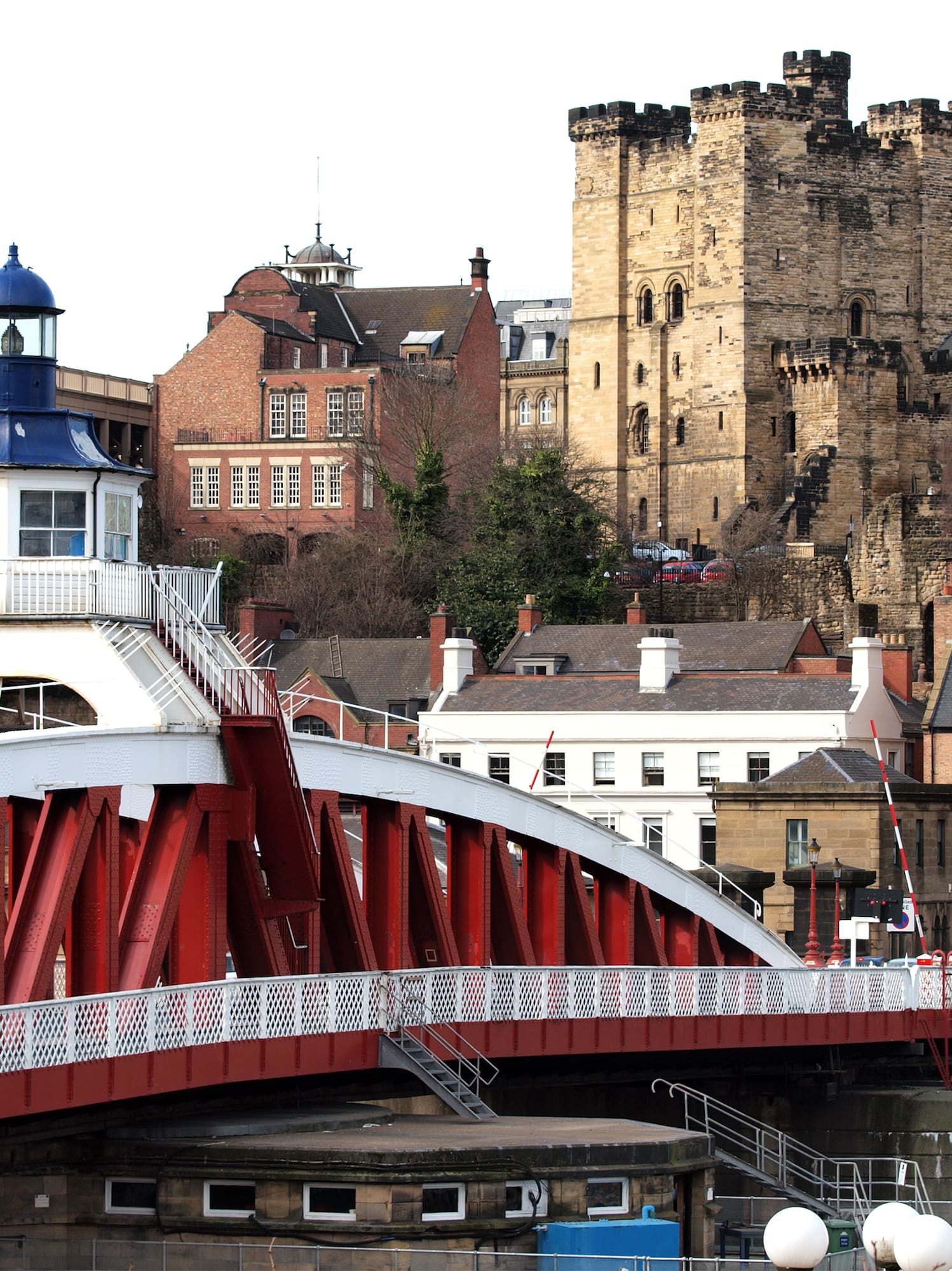 a bridge over a river with a lighthouse