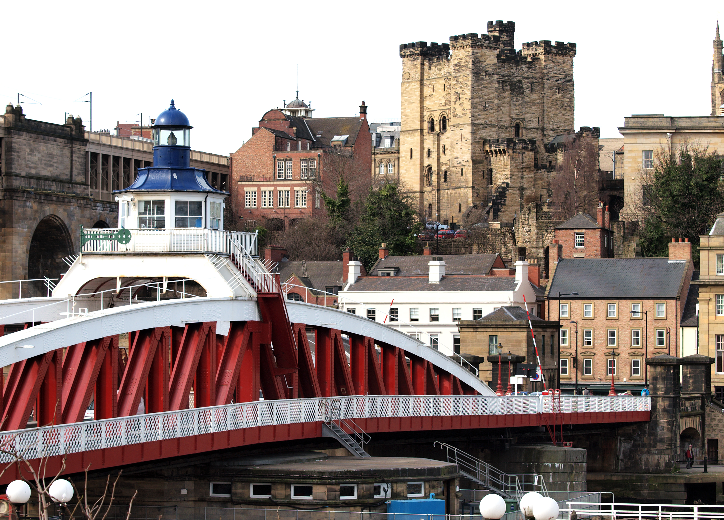a bridge over a river with a lighthouse