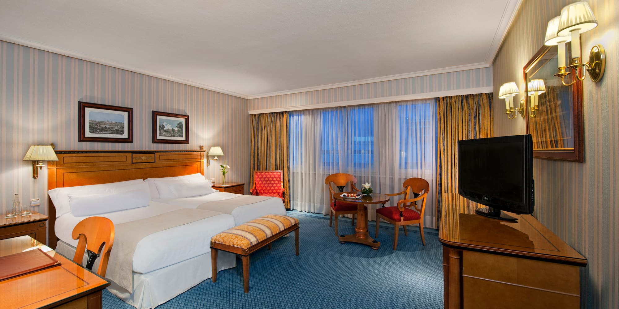 a room with a bed and a television