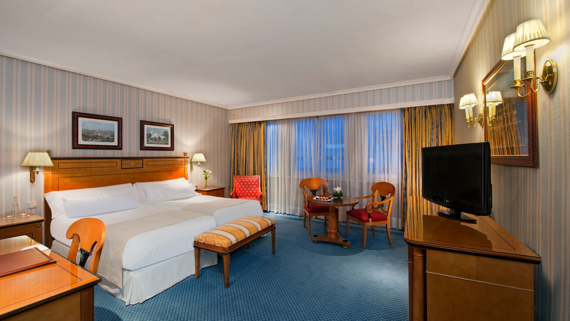 a room with a bed and a television