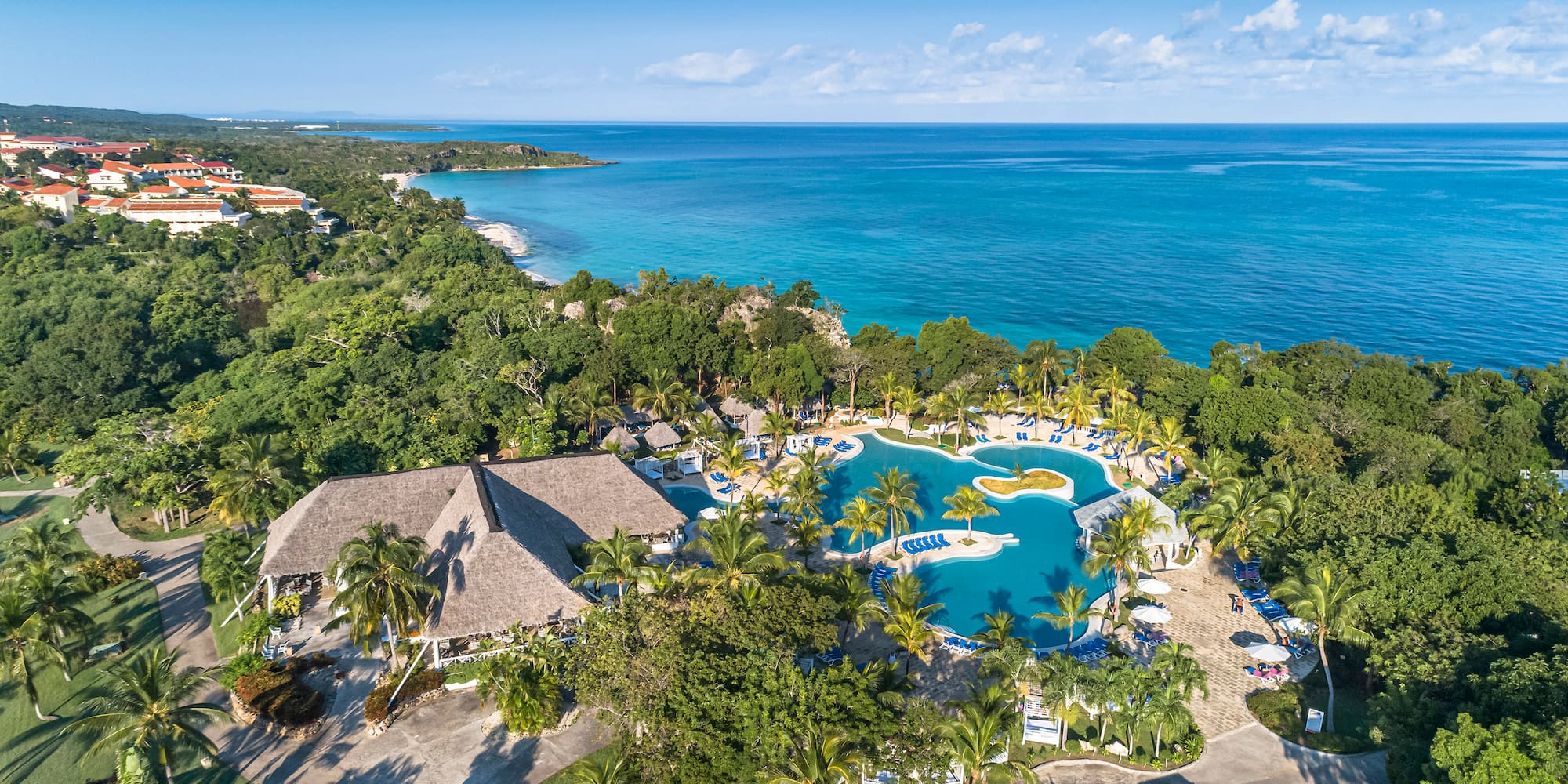 a swimming pool surrounded by trees and a body of water