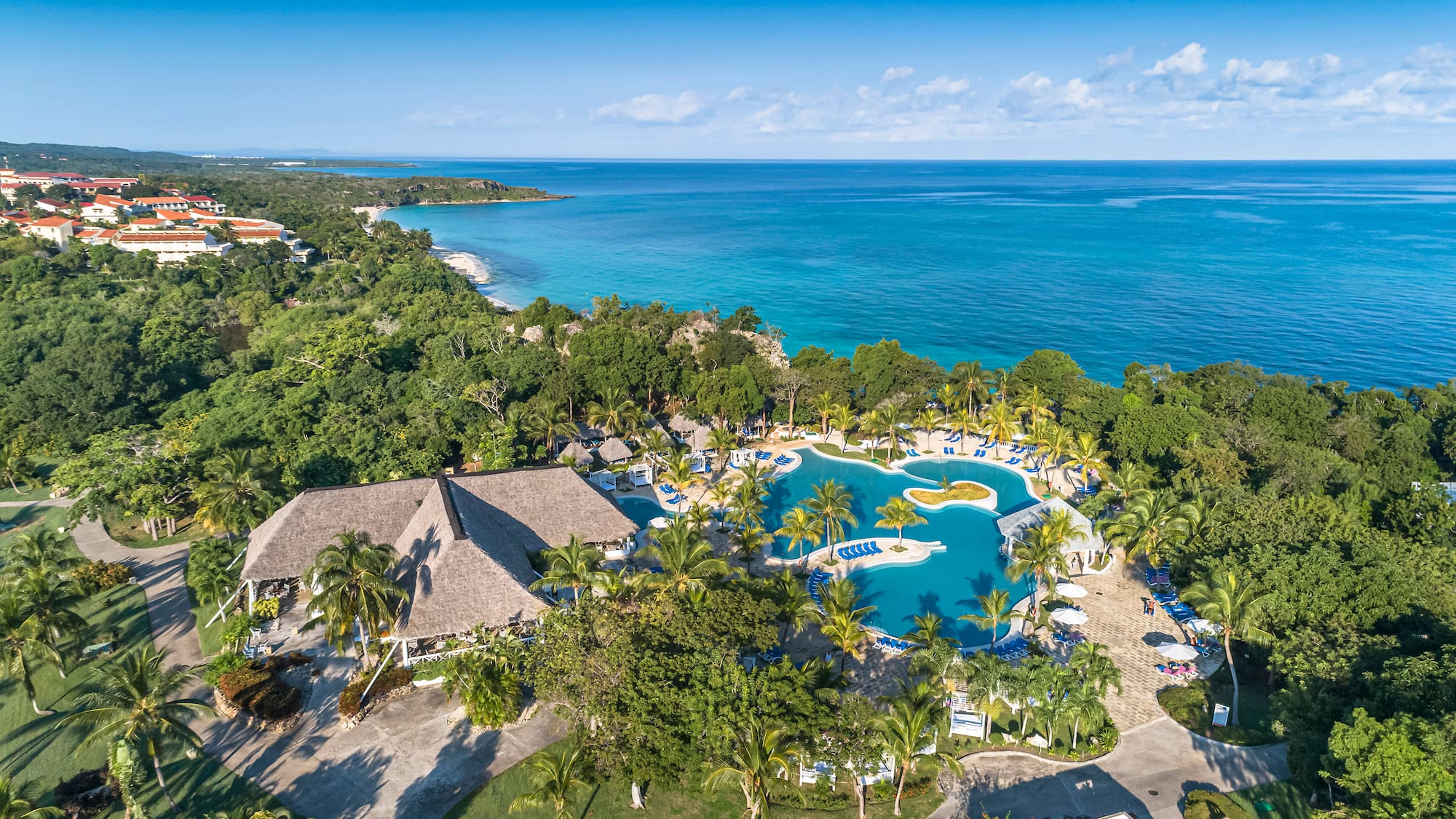 a swimming pool surrounded by trees and a body of water