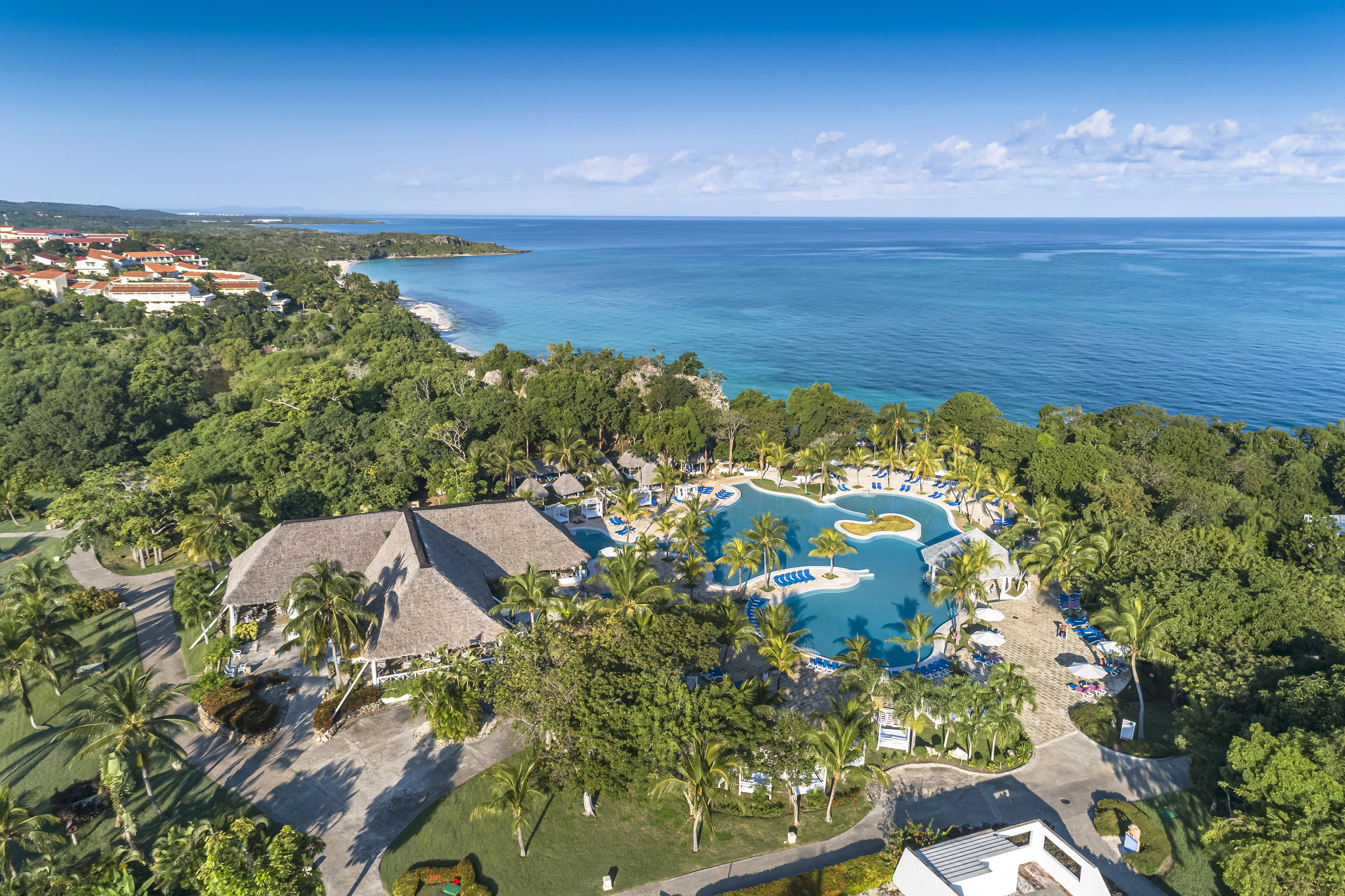 a swimming pool surrounded by trees and a body of water