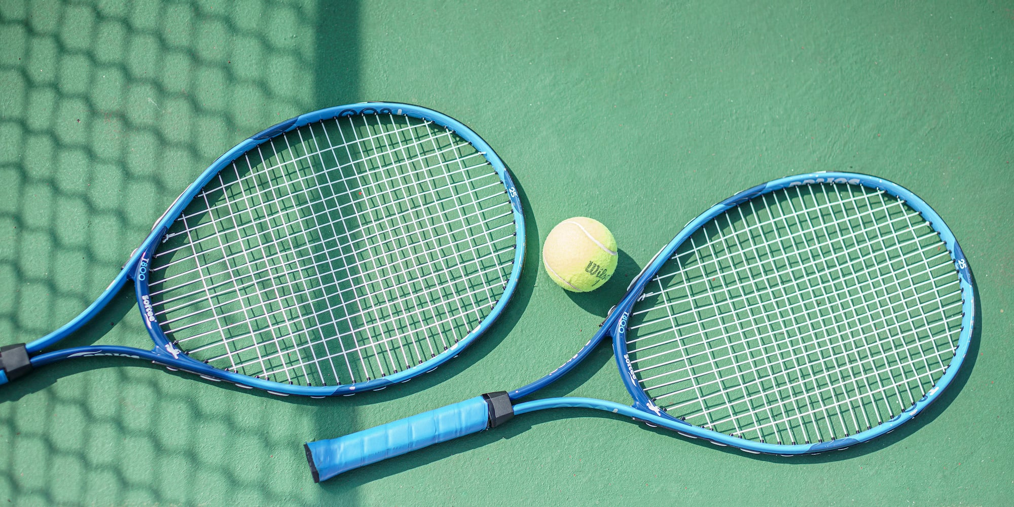 a tennis rackets and a ball on a court
