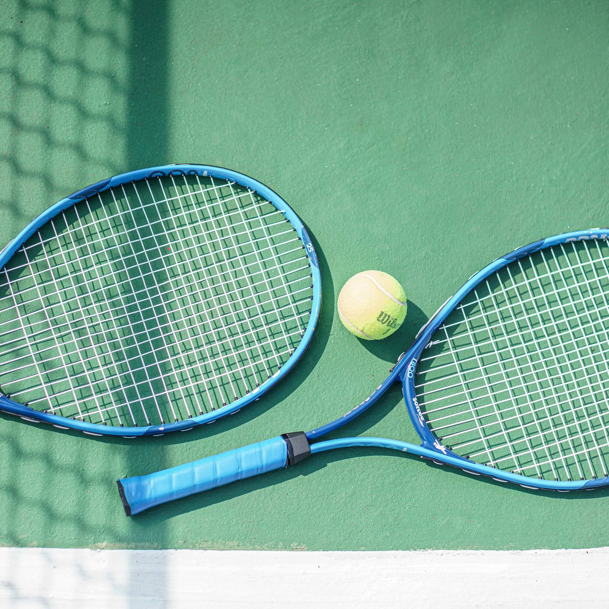 a tennis rackets and a ball on a court