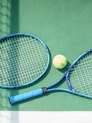 a tennis rackets and a ball on a court