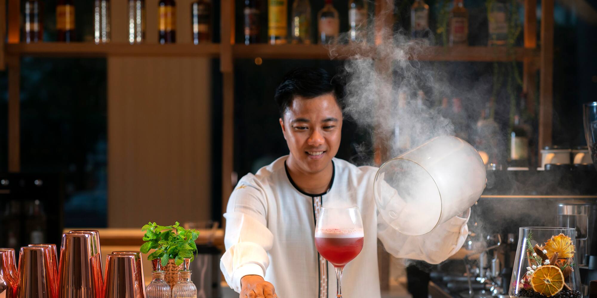 a man pouring liquid into a glass