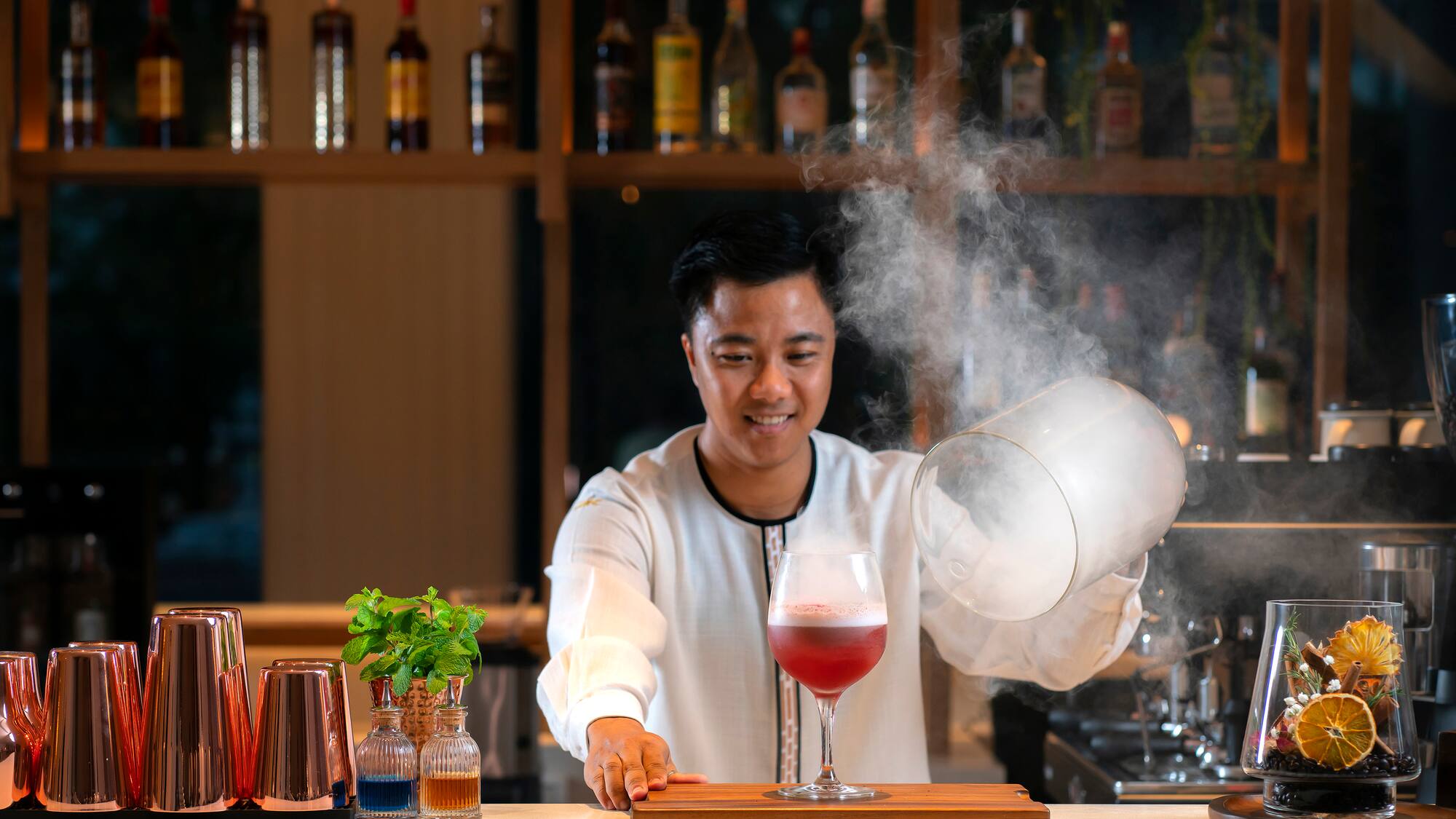 a man pouring liquid into a glass