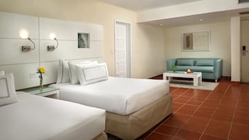 a room with two beds and a couch