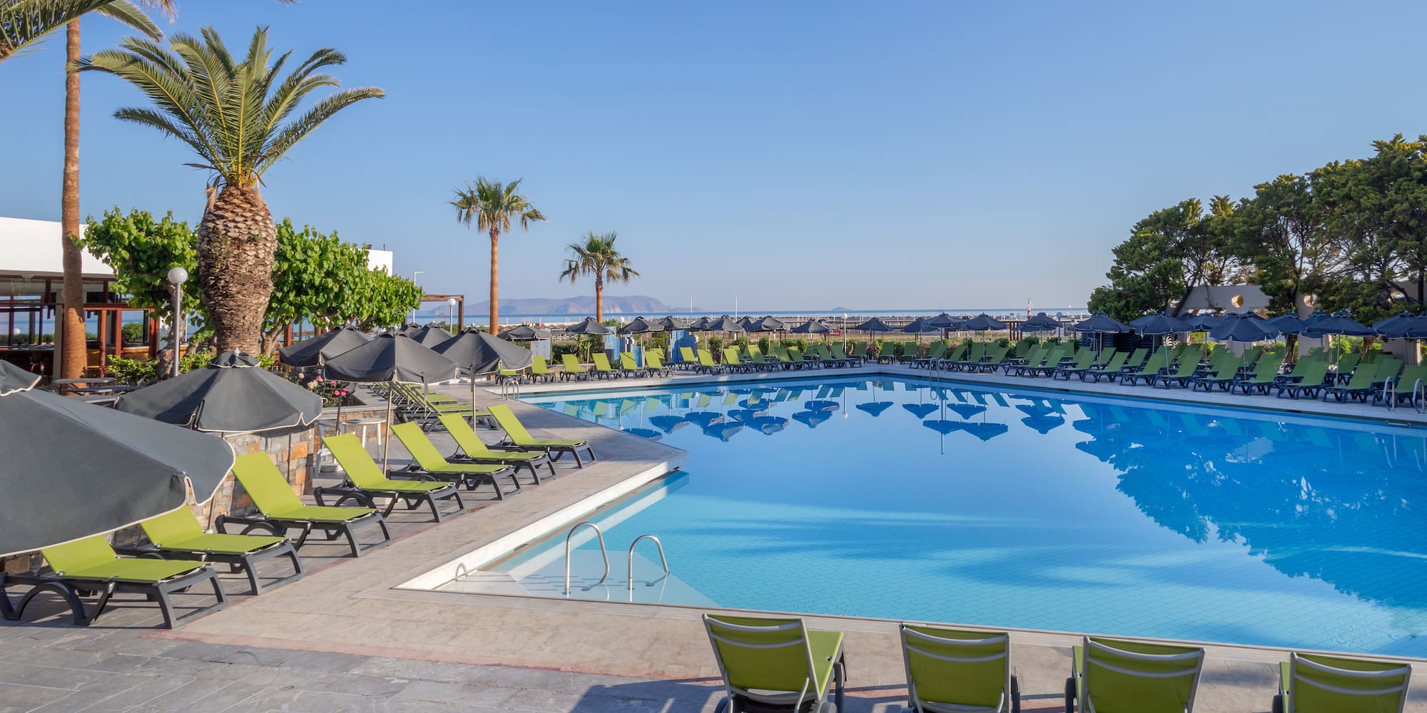a pool with lounge chairs and umbrellas