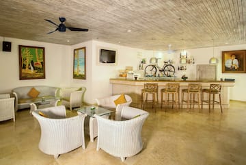 a room with a bar and chairs