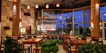 a room with tables and chairs and plants