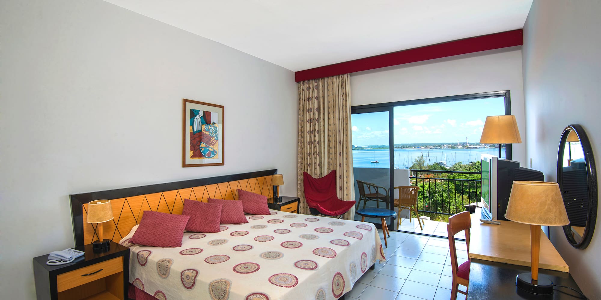 a bedroom with a bed and a table and chairs