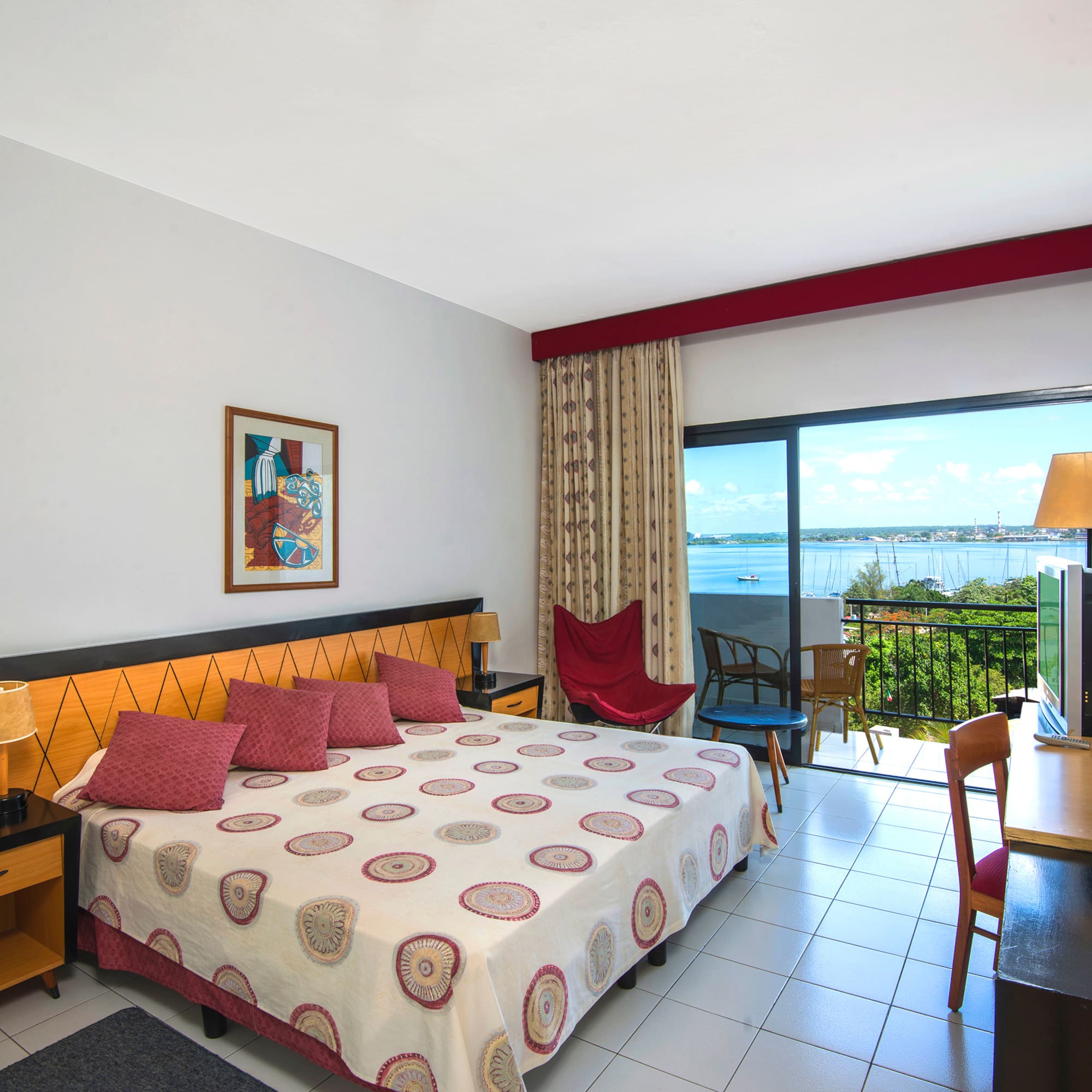 a bedroom with a bed and a table and chairs