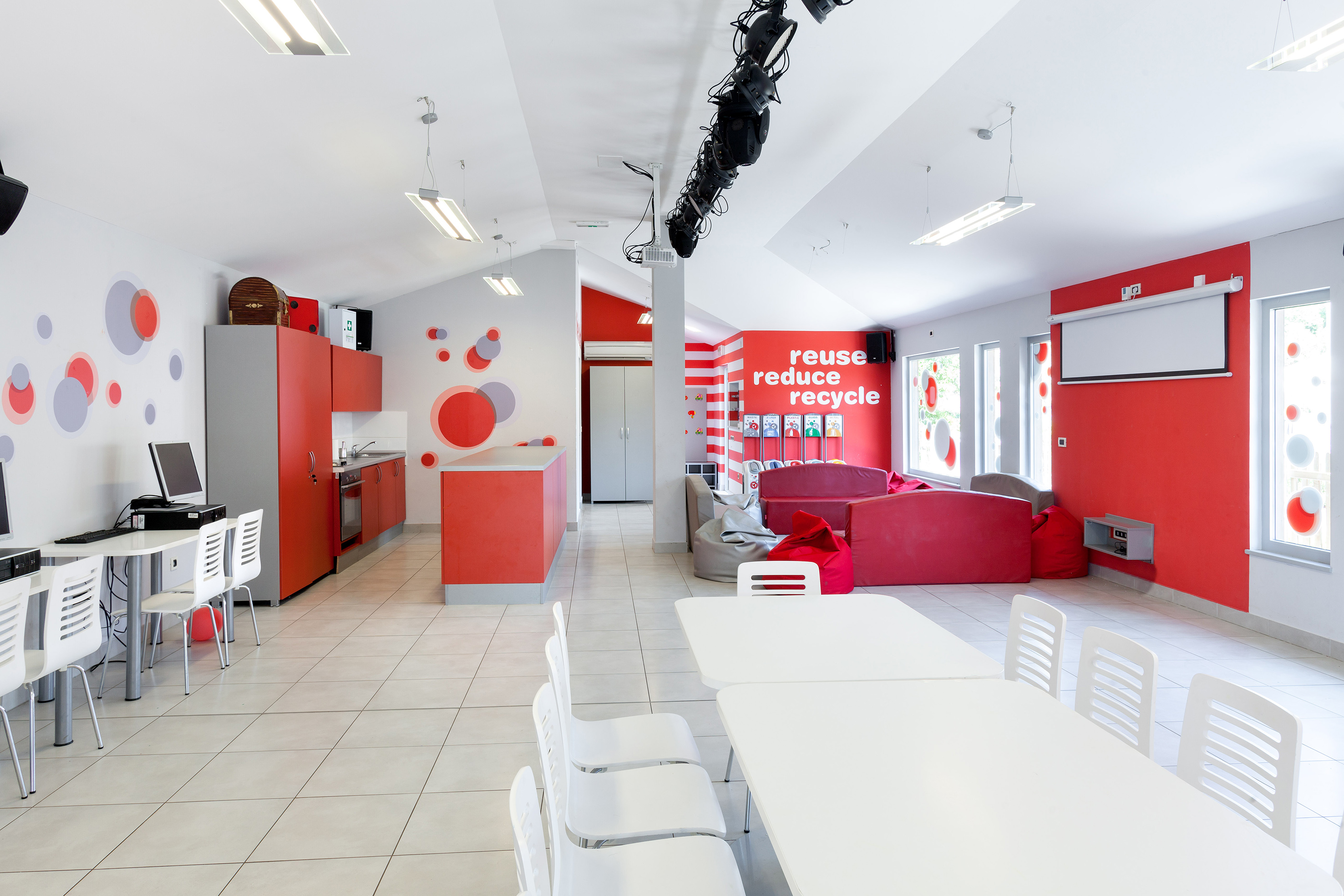 a room with white tables and chairs