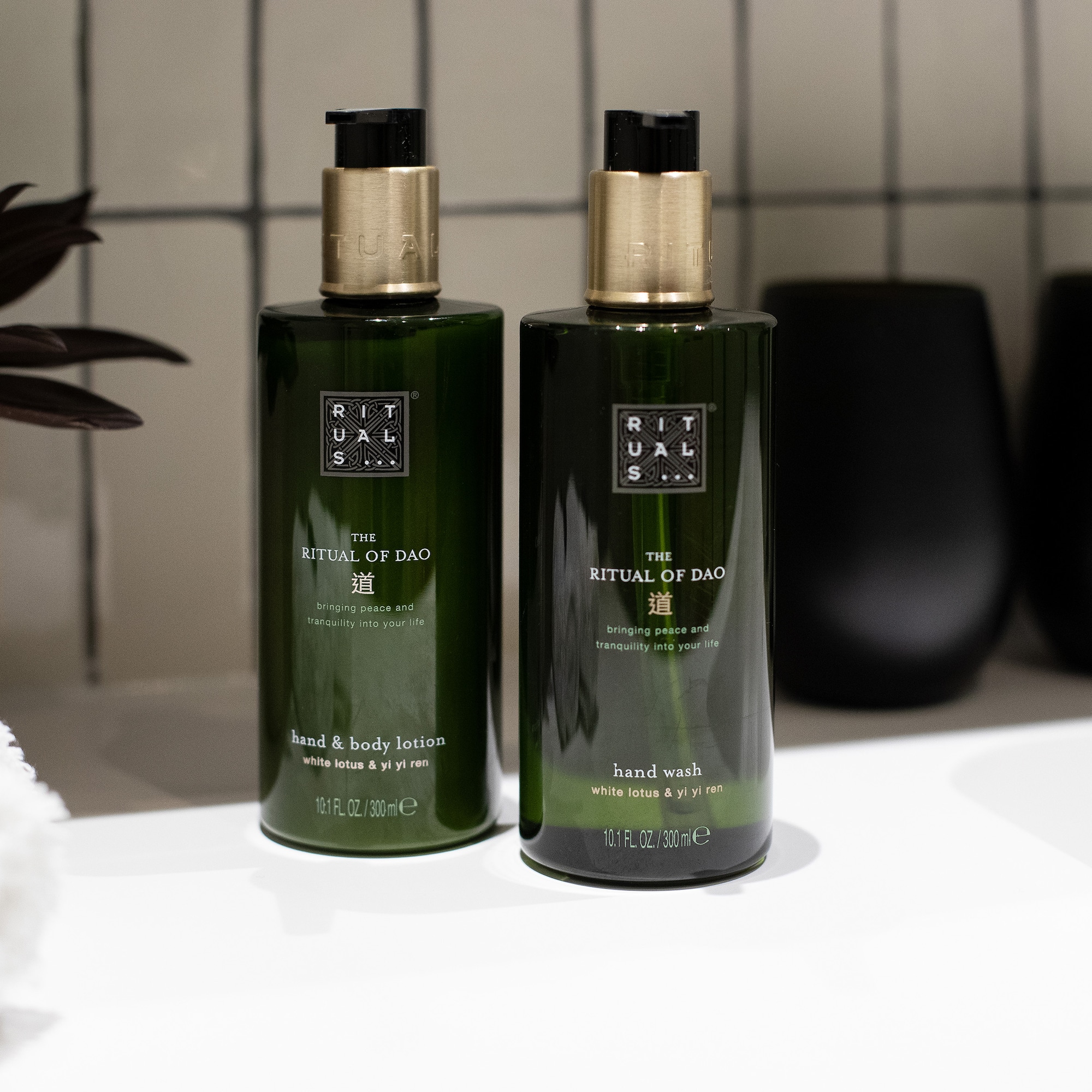 a couple of green bottles on a white counter