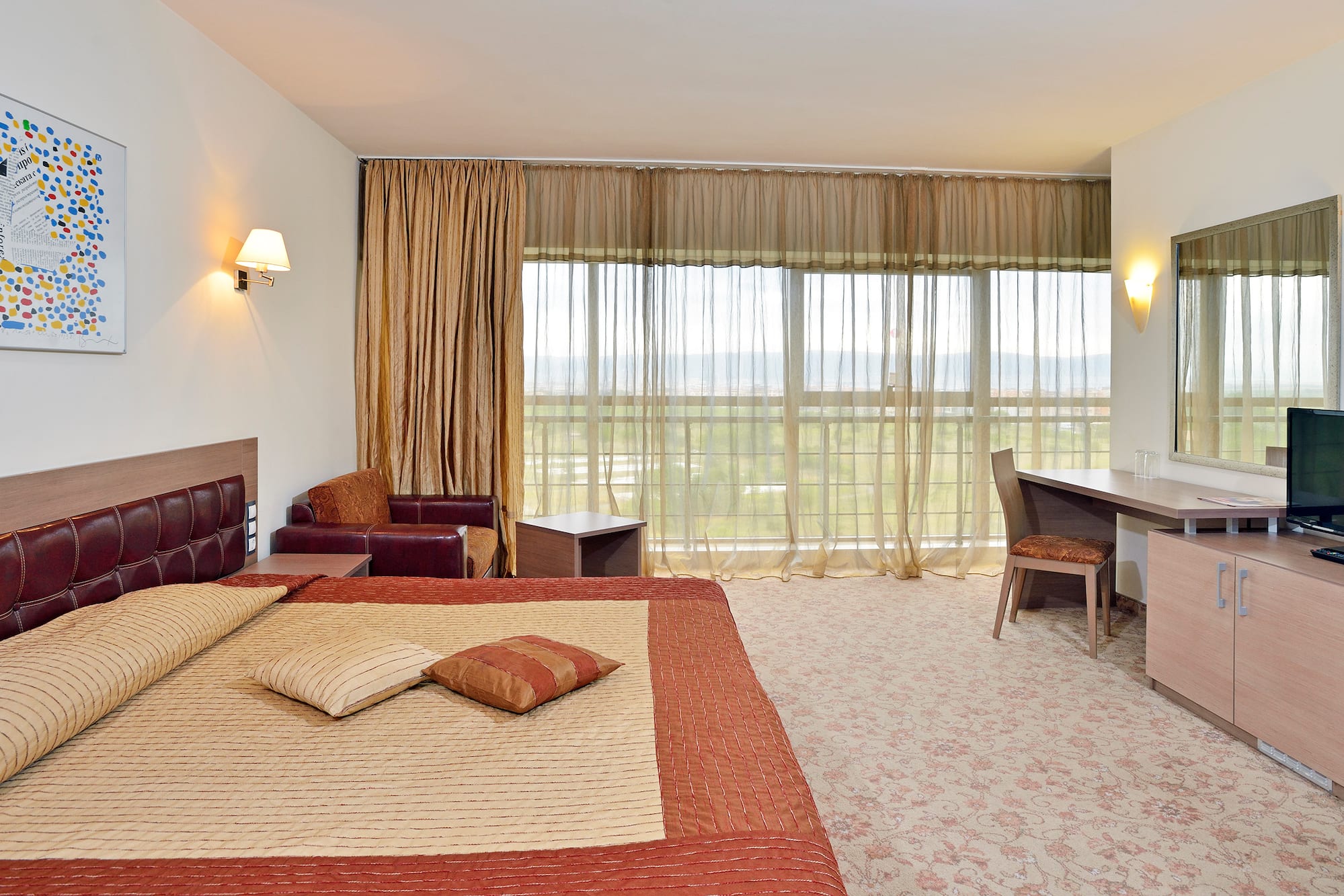 a bedroom with a bed and a desk