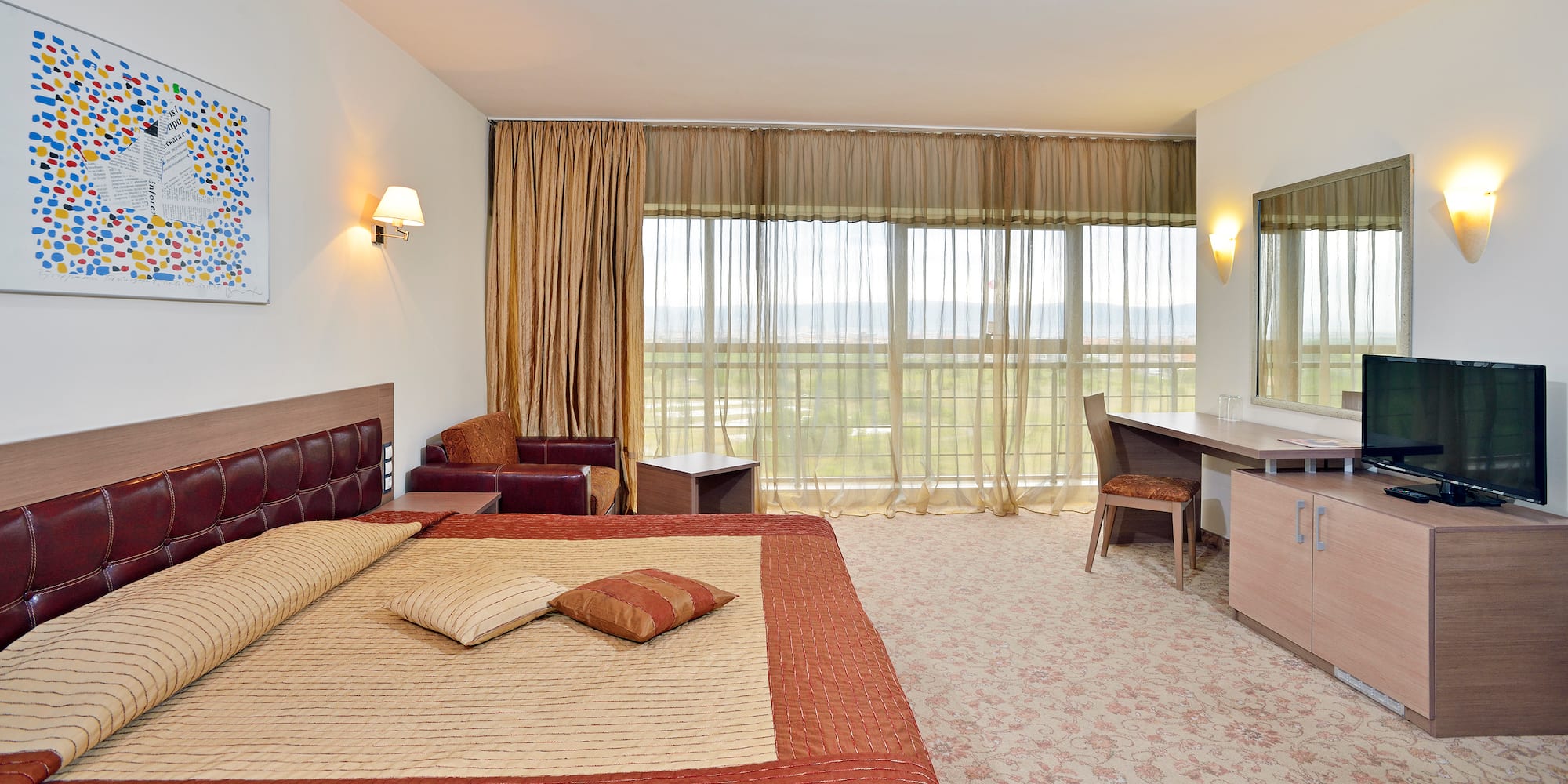 a bedroom with a bed and a desk