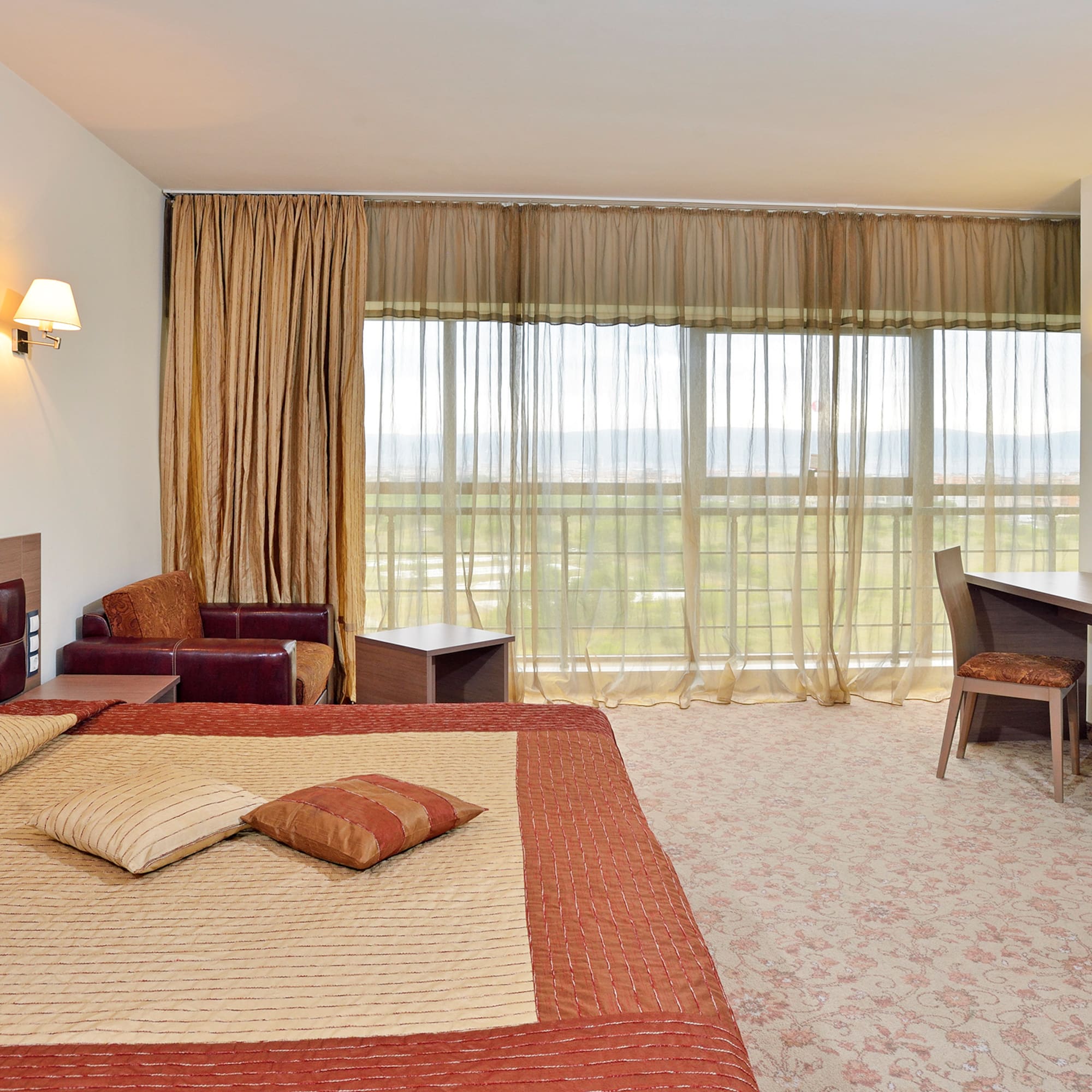 a bedroom with a bed and a desk