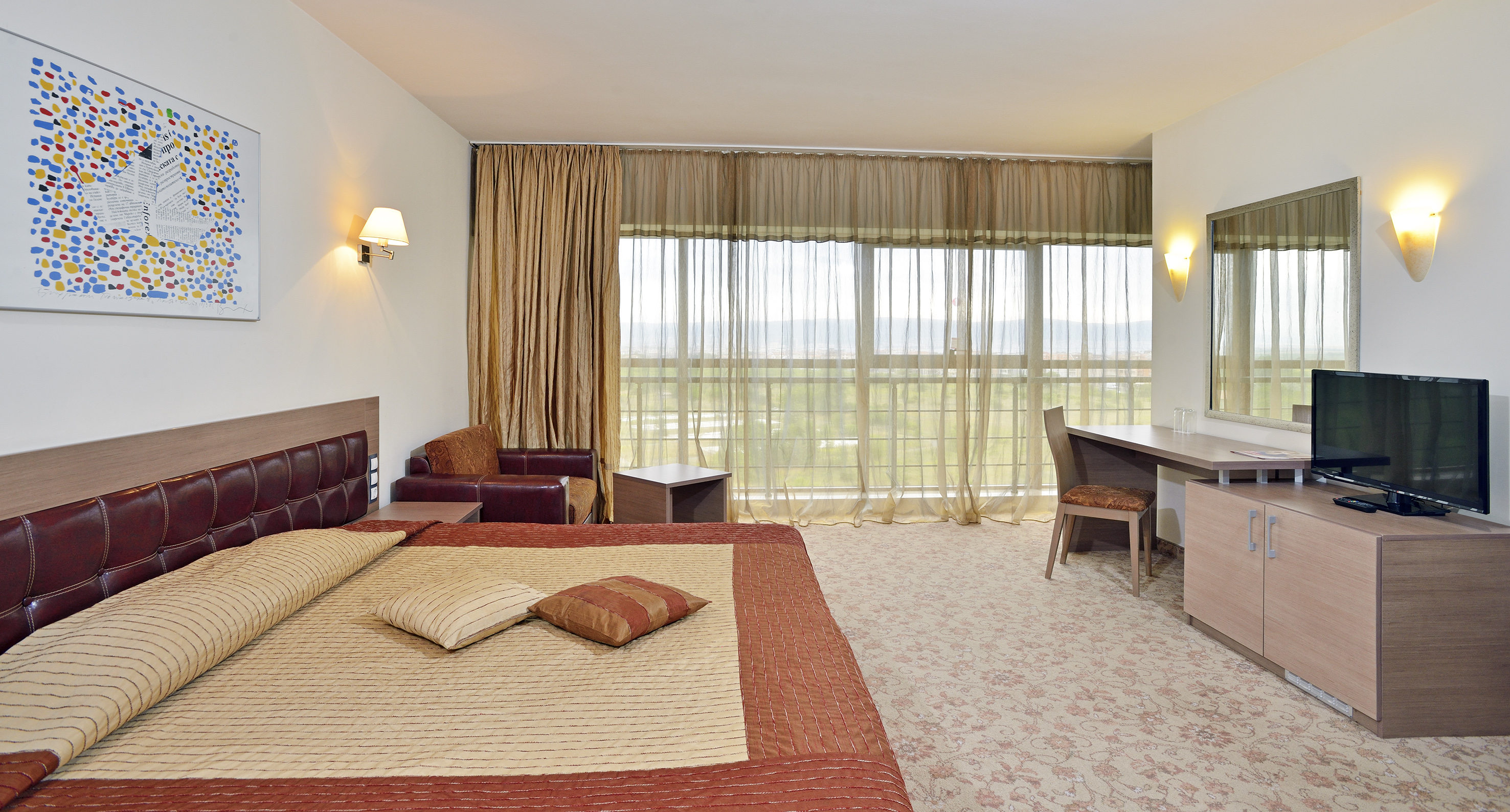 a bedroom with a bed and a desk