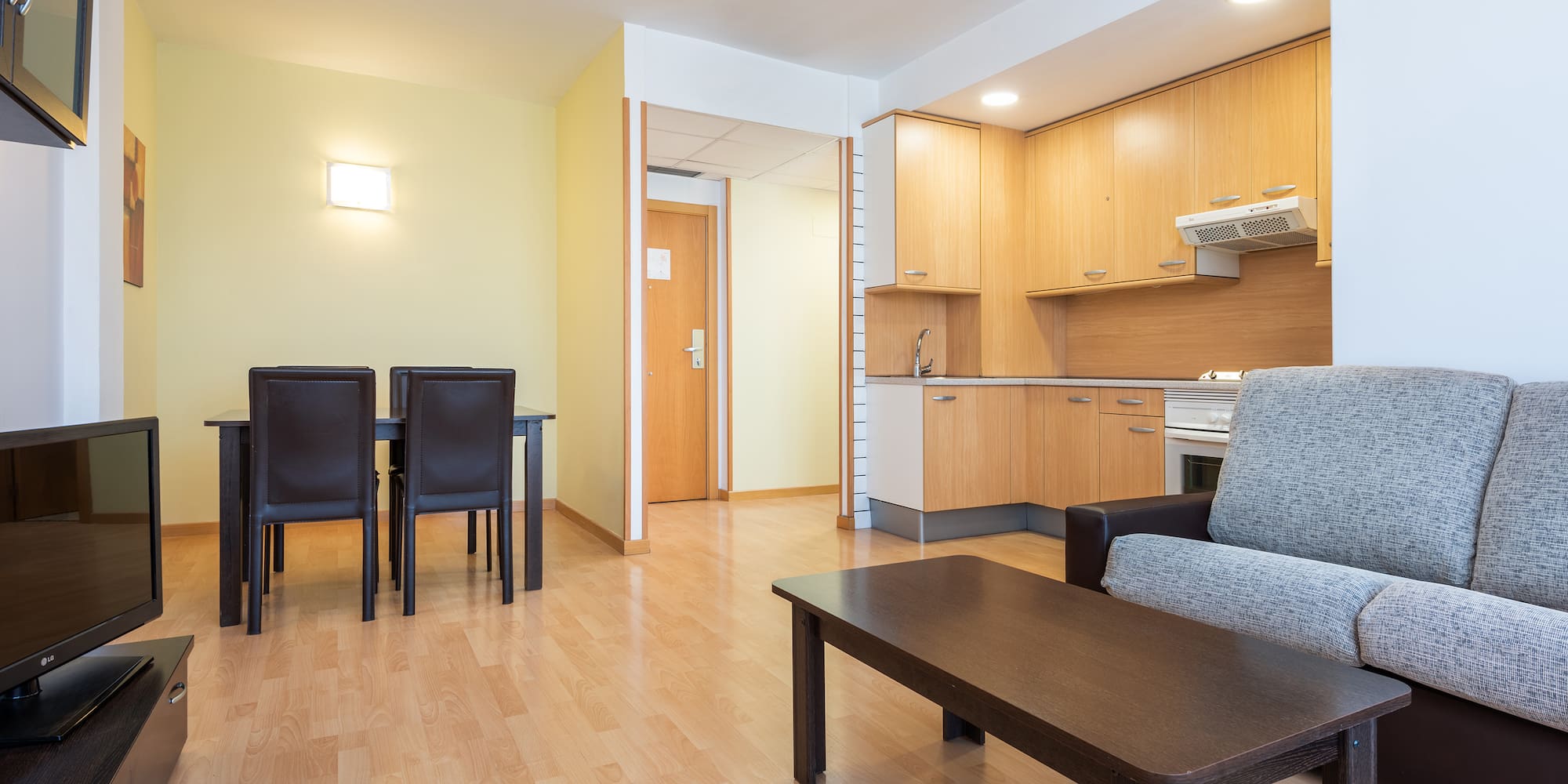a living room with a table and chairs